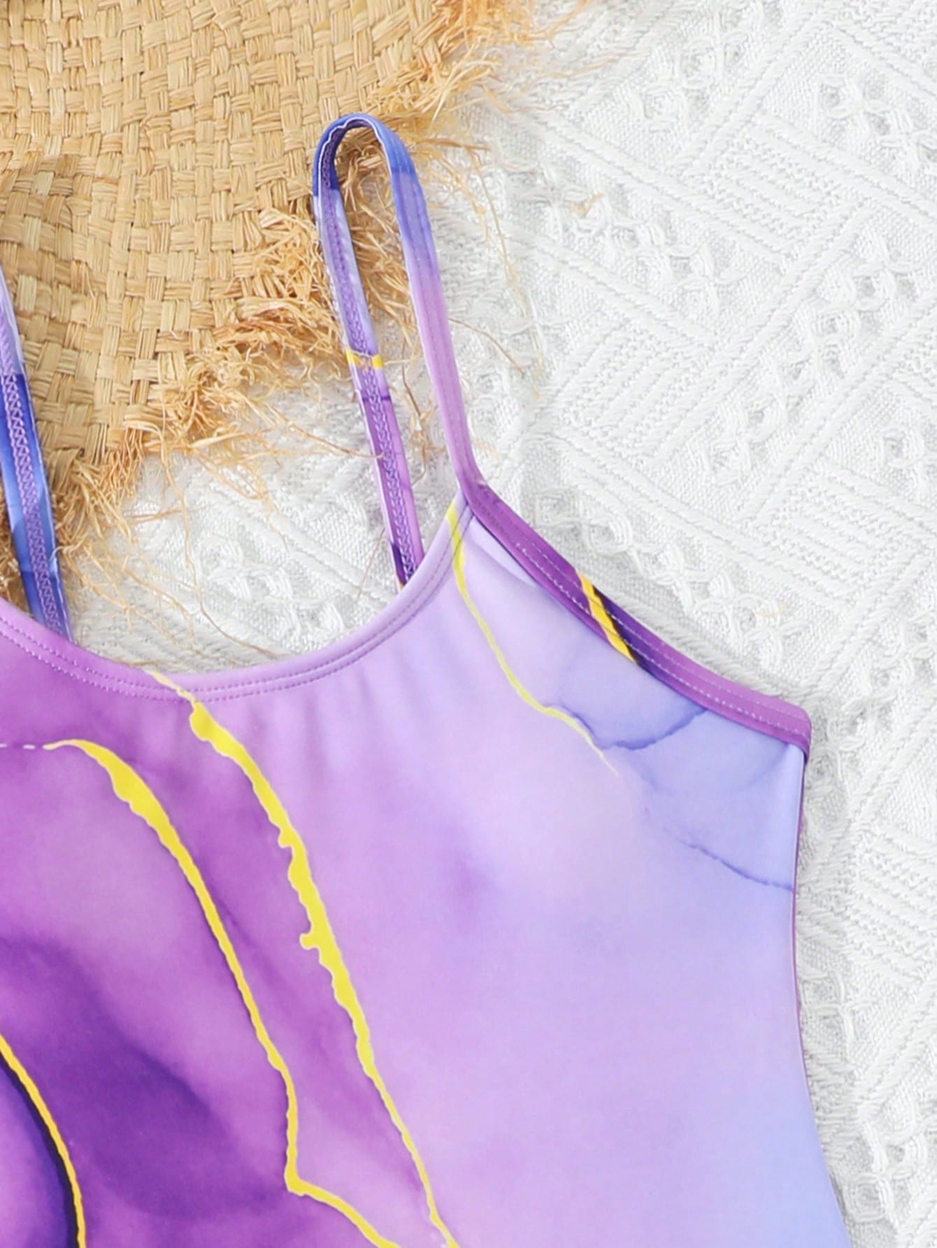 Purple tween girls one-piece swimsuit set with spaghetti straps, graphic all-over print, pocket detail, and matching long pants for beach or pool vacation wear.