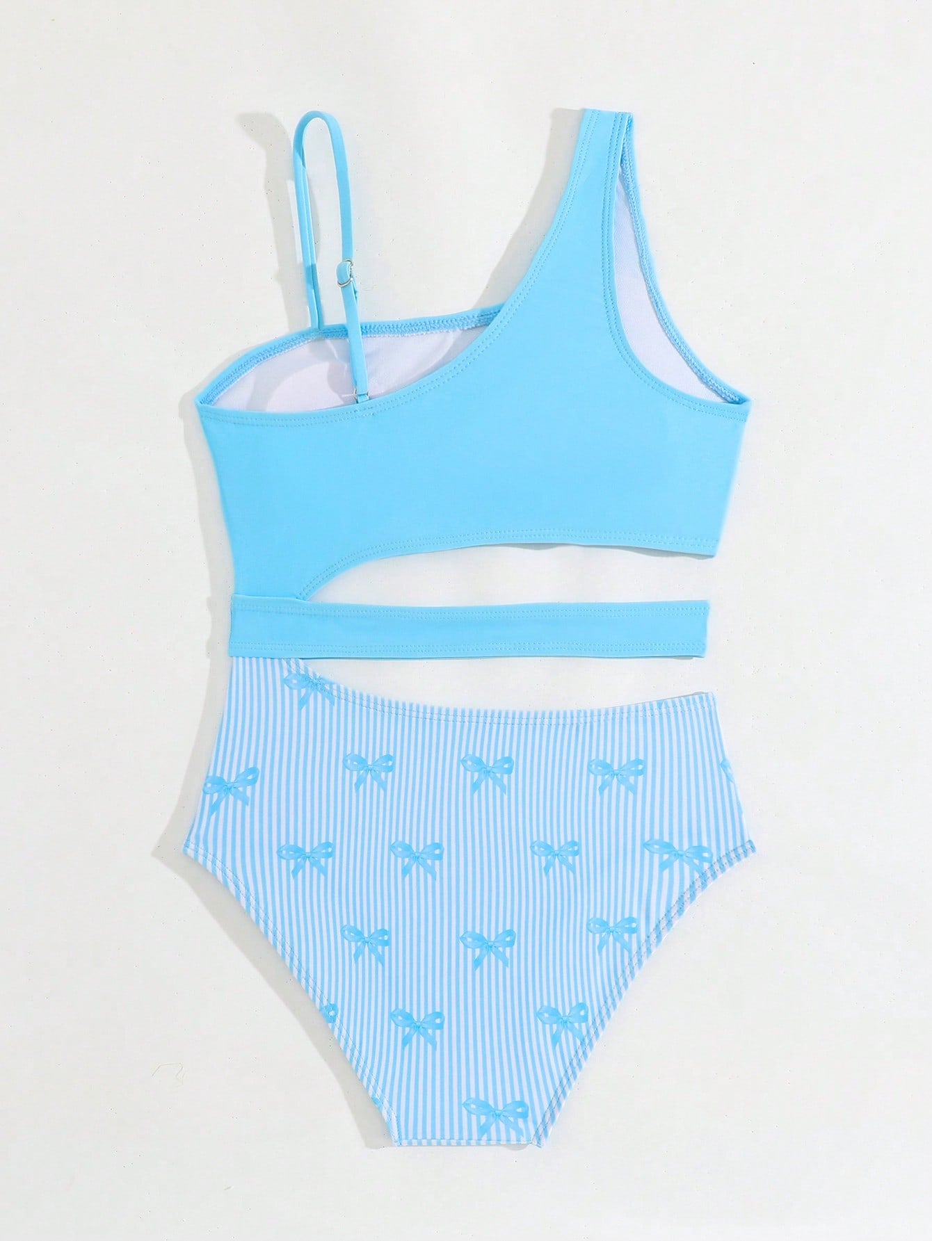 Purple tween girls one-piece swimsuit with asymmetrical neckline, cut-out waist, striped pattern, fitted silhouette, and lined body.