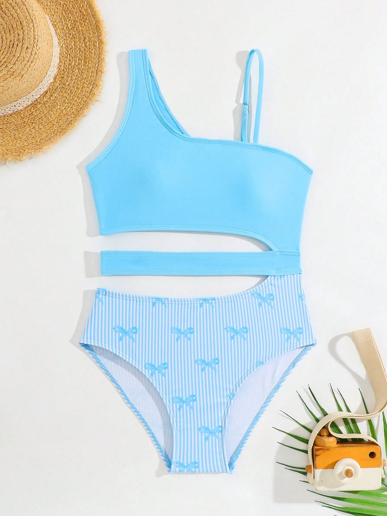 Purple tween girls one-piece swimsuit with asymmetrical neckline, cut-out waist, striped pattern, fitted silhouette, and lined body.