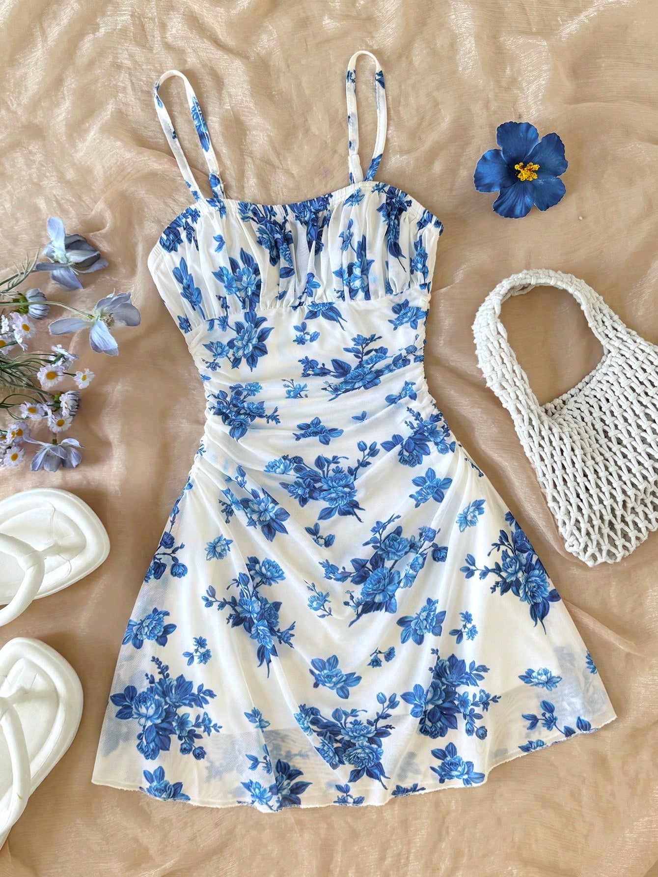 Tween girl yellow mini sundress with large pink floral hibiscus print, spaghetti straps, high waist, flared hem, and sleeveless cami style for summer beach wear