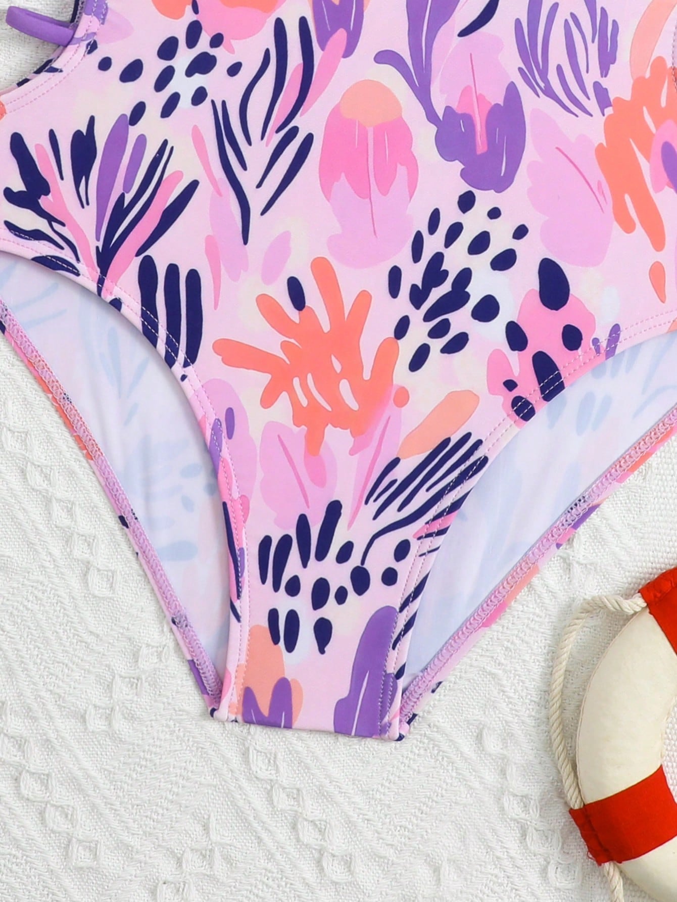 Tween girl multicolor one-piece swimsuit with gradient heart graphic print, scoop neck, cutout detail, and fitted vacation beachwear style.