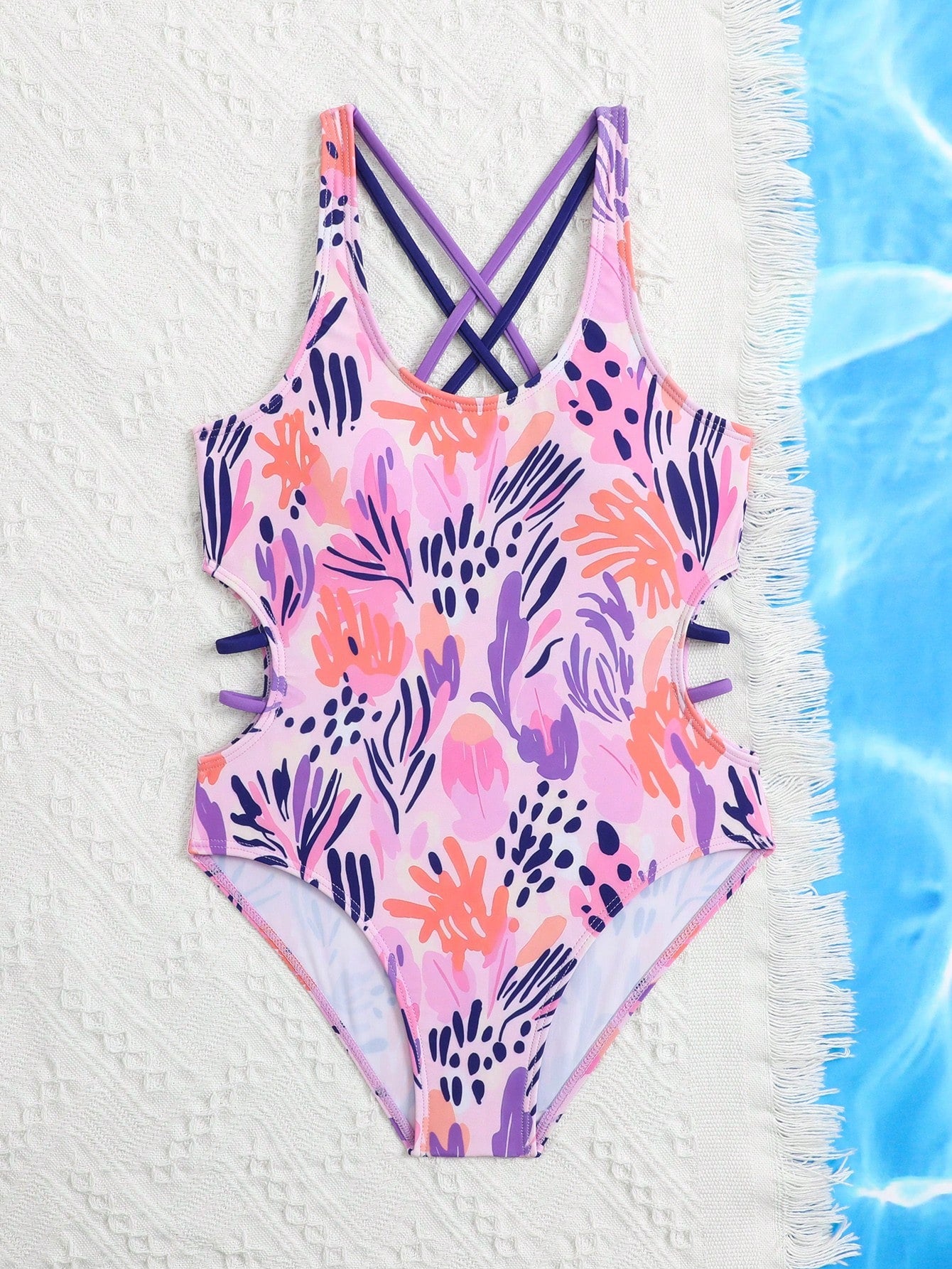 Tween girl multicolor one-piece swimsuit with gradient heart graphic print, scoop neck, cutout detail, and fitted vacation beachwear style.