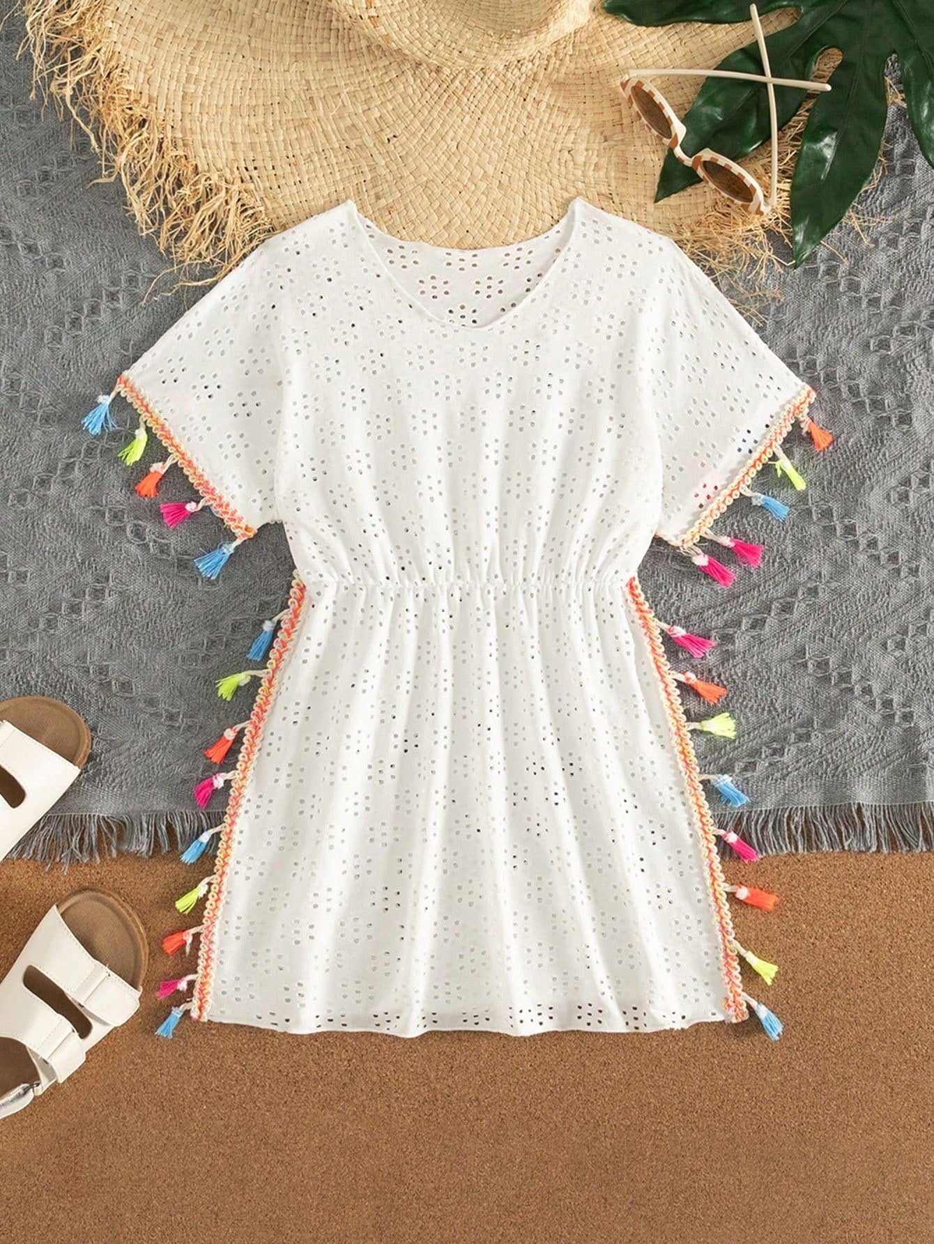 Tween girl white swimsuit cover up with colorful tassel fringe, hollow crochet mesh, round neck, short sleeves, and semi-sheer beach dress style.