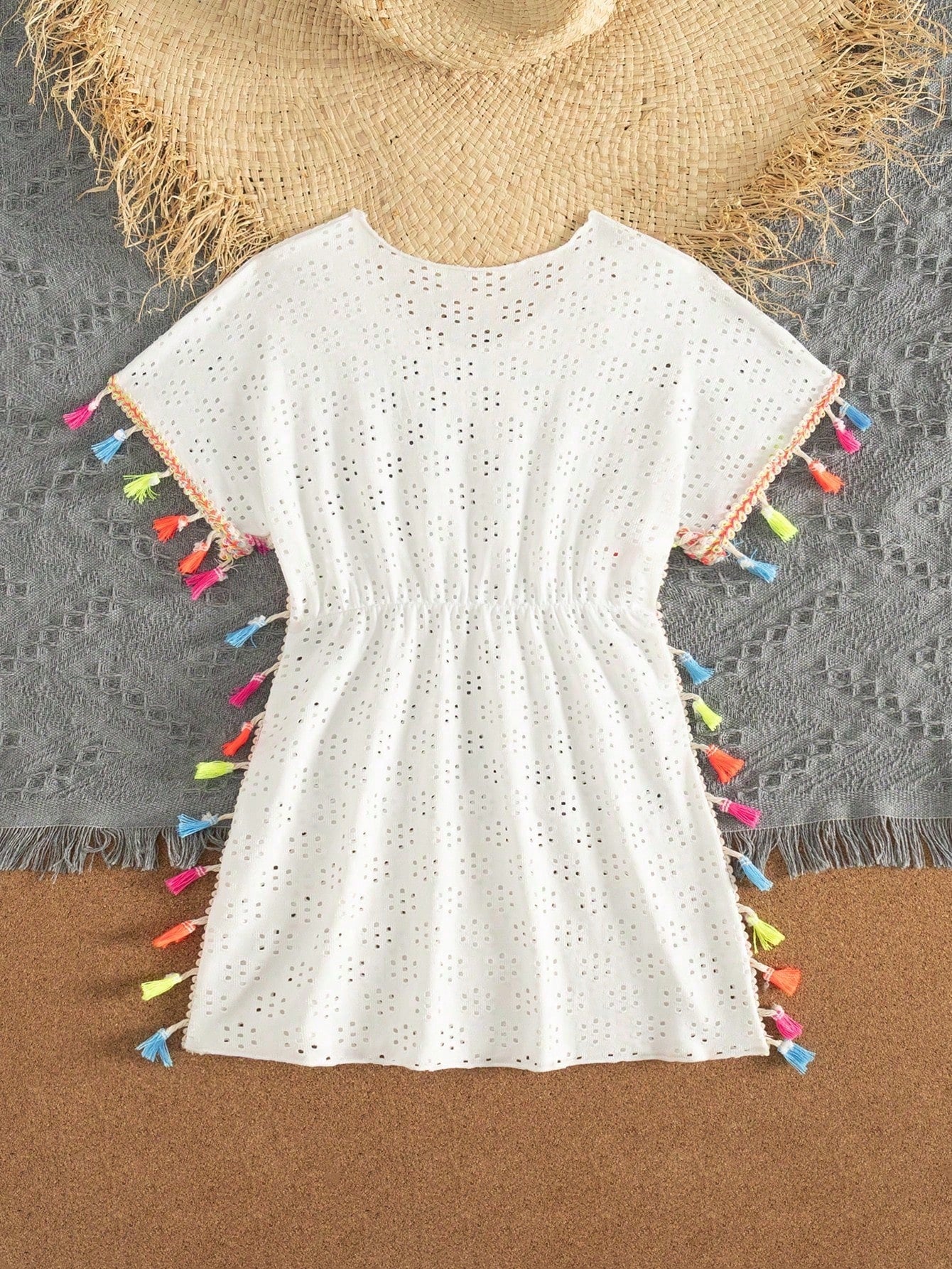 Tween girl white swimsuit cover up with colorful tassel fringe, hollow crochet mesh, round neck, short sleeves, and semi-sheer beach dress style.
