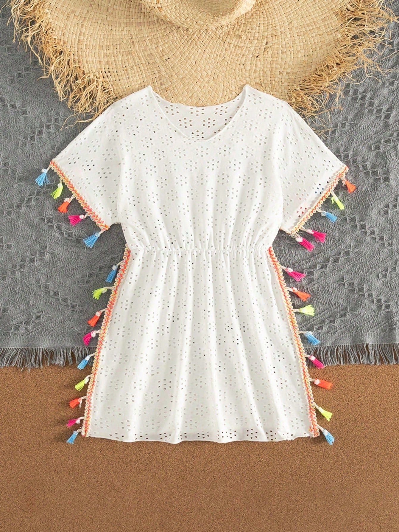 Tween girl white swimsuit cover up with colorful tassel fringe, hollow crochet mesh, round neck, short sleeves, and semi-sheer beach dress style.