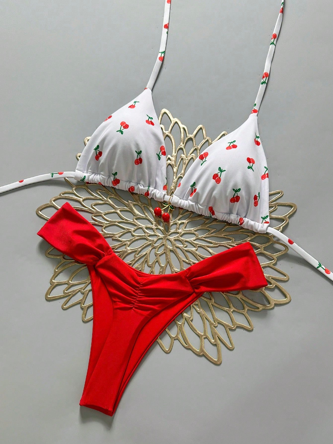 Women's 2-piece triangle cup bikini set in solid color featuring woven pearl shell decoration, halter neckline, and high-waist side-tie ruched bottoms.