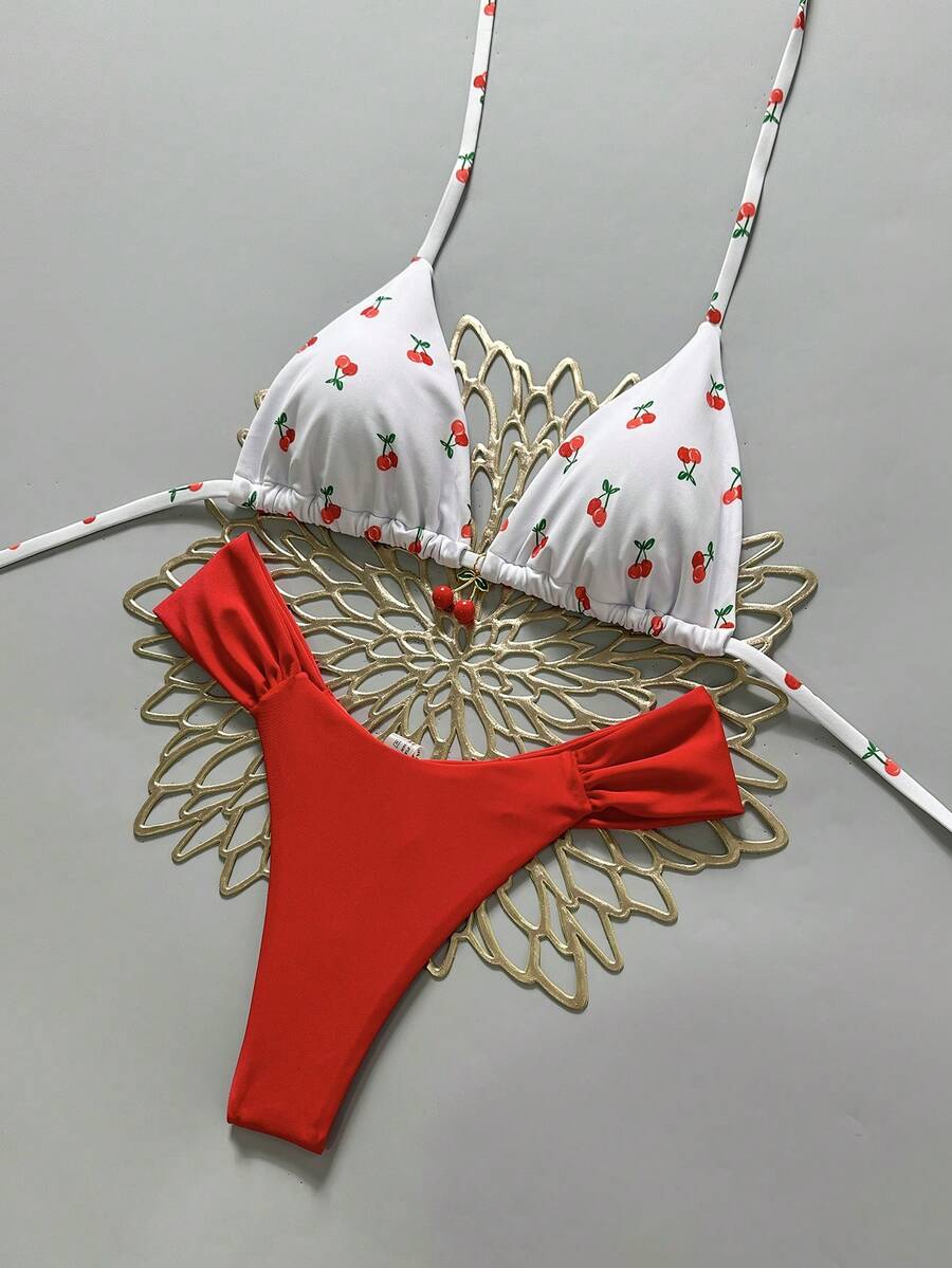 Women's 2-piece triangle cup bikini set in solid color featuring woven pearl shell decoration, halter neckline, and high-waist side-tie ruched bottoms.