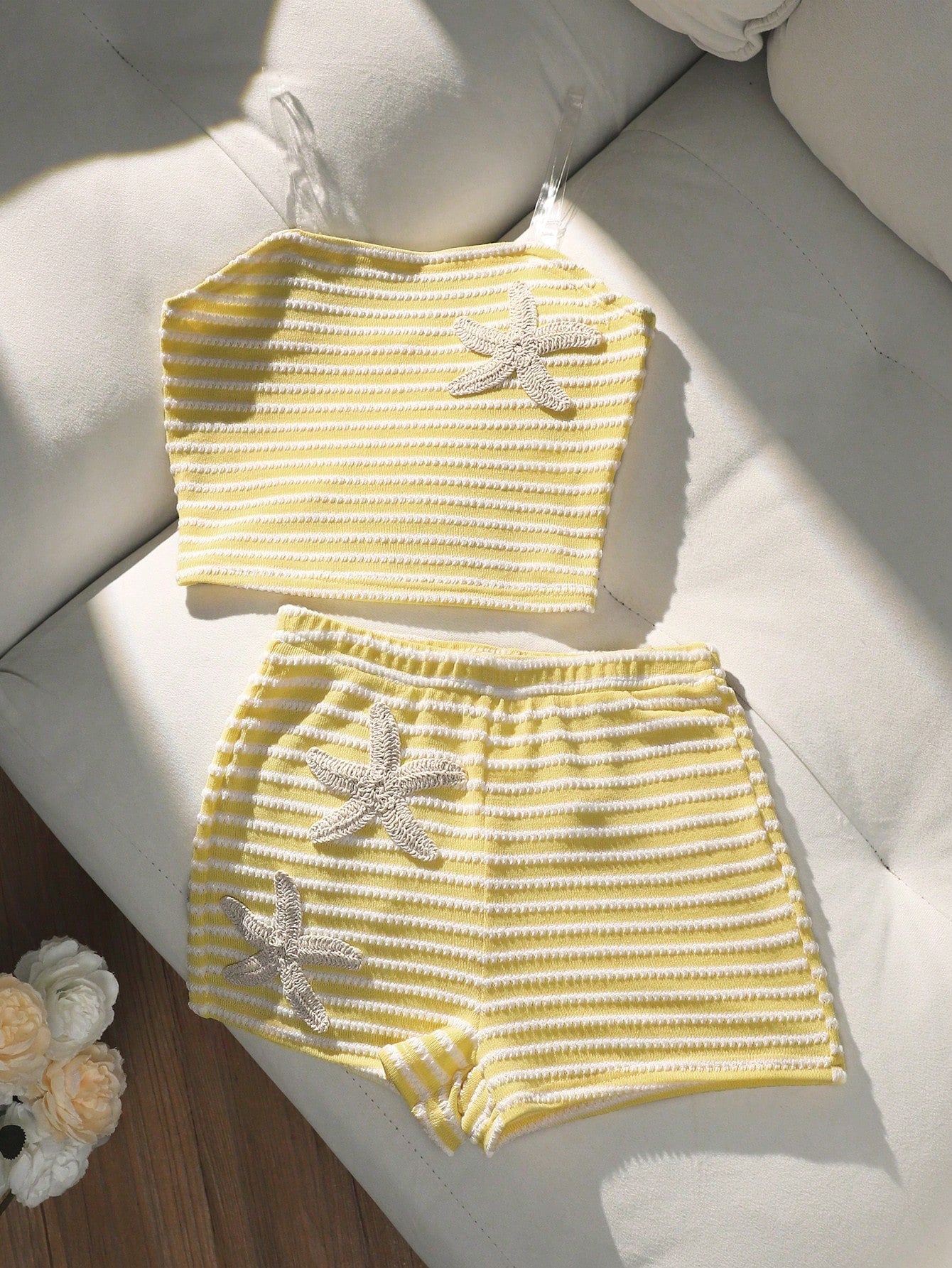 Tween girls black and white striped two-piece set featuring a spaghetti strap micro crop tank top with lettuce trim and ruffle hem paired with matching slim fit shorts.