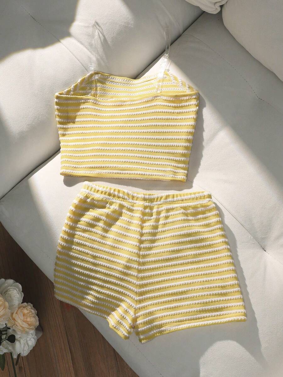 Tween girls black and white striped two-piece set featuring a spaghetti strap micro crop tank top with lettuce trim and ruffle hem paired with matching slim fit shorts.