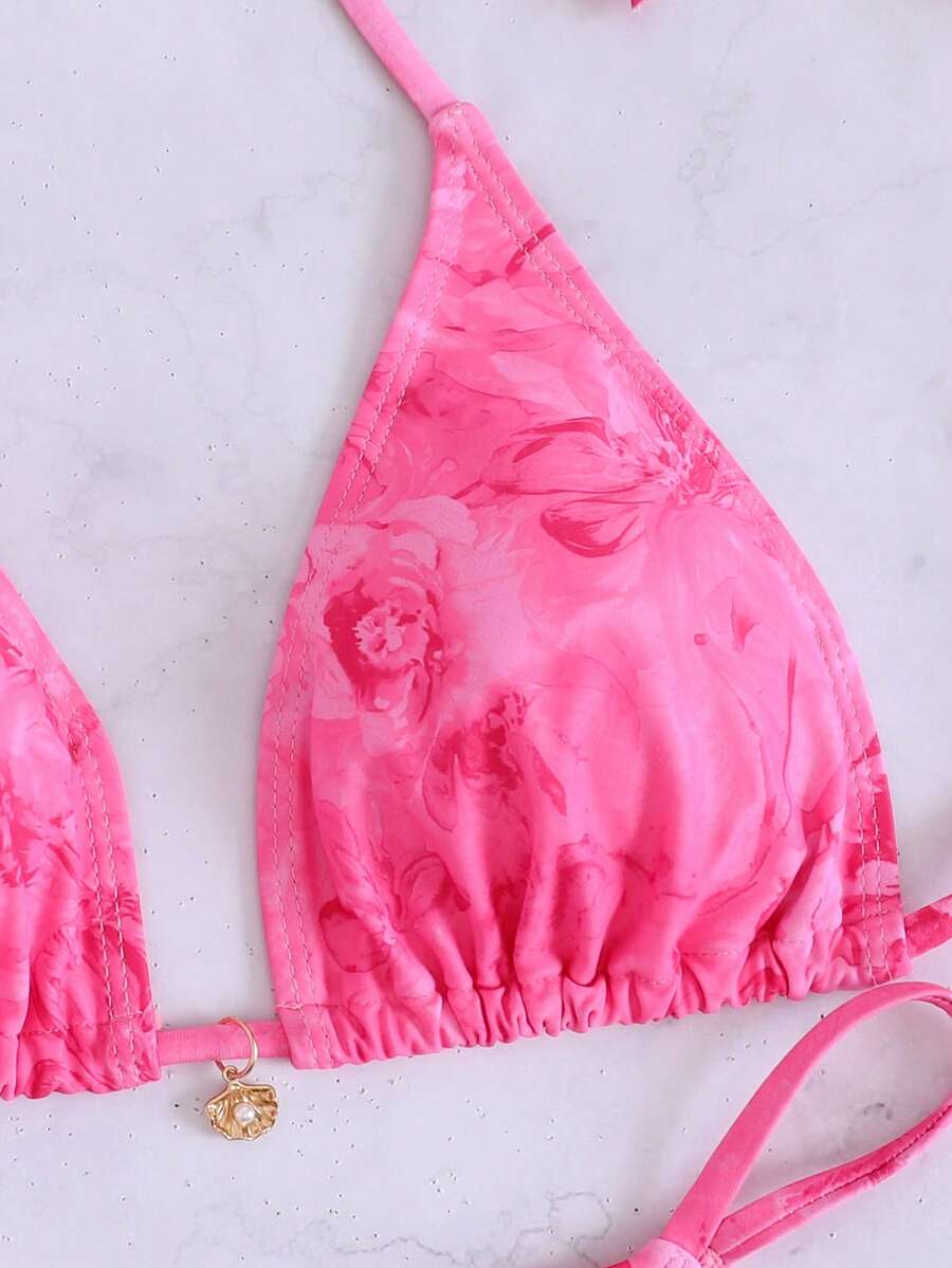 Women's 3-piece floral swimsuit set featuring a multicolor tie-back halter bikini top, low-waist bottoms, and a matching sheer mesh maxi skirt.