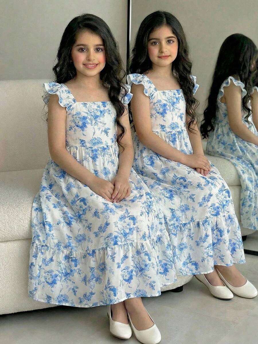 Blue floral print long vacation dress for tween girls featuring an A-line high waist silhouette with ruffle details and spaghetti straps.