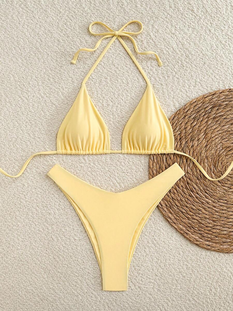 Polka dot halter bikini set for women featuring a back-tie triangle top with removable padding and high-waist high-cut bikini bottoms.