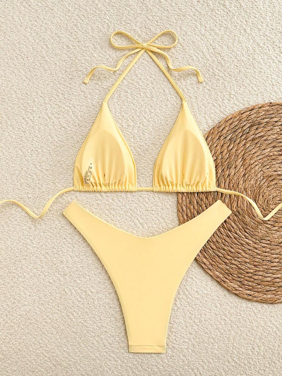 Polka dot halter bikini set for women featuring a back-tie triangle top with removable padding and high-waist high-cut bikini bottoms.