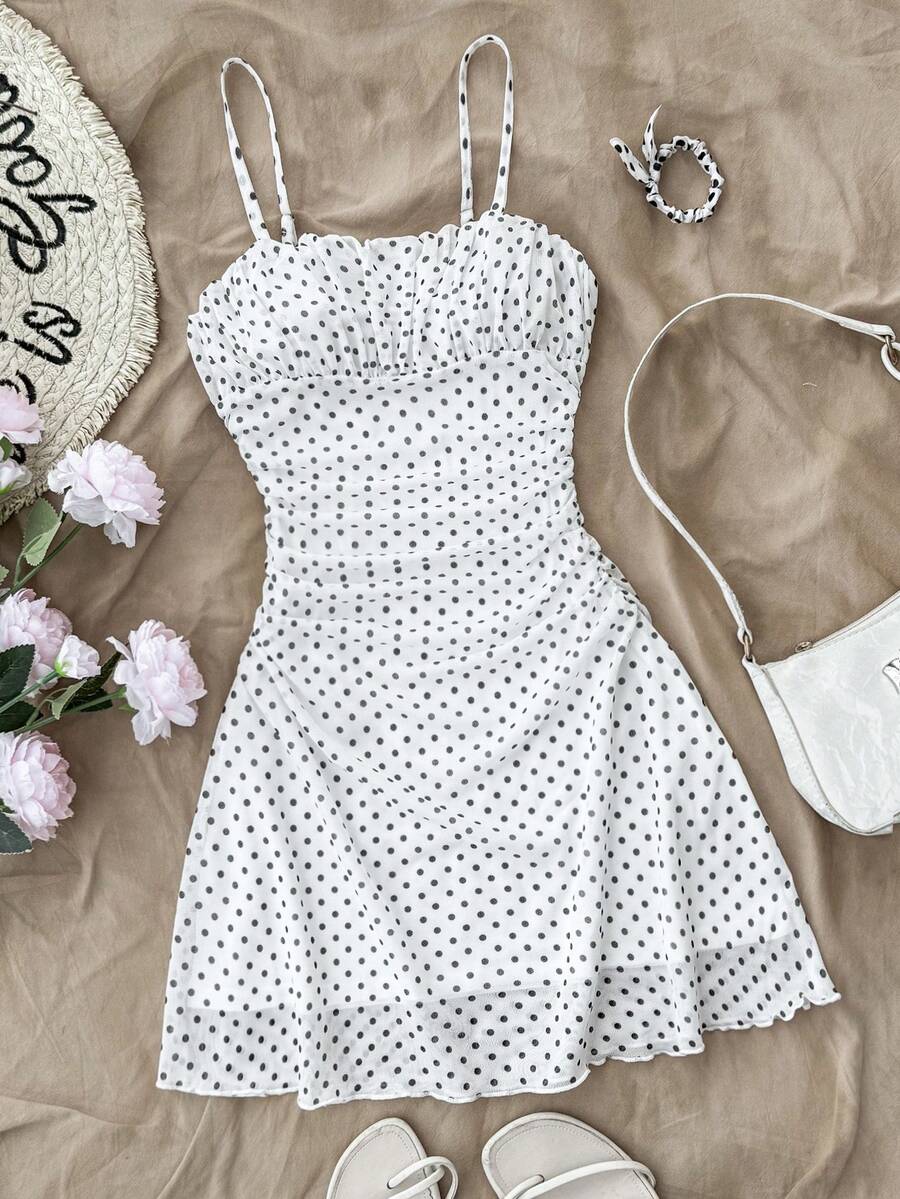 Tween girl yellow mini sundress with large pink floral hibiscus print, spaghetti straps, high waist, flared hem, and sleeveless cami style for summer beach wear