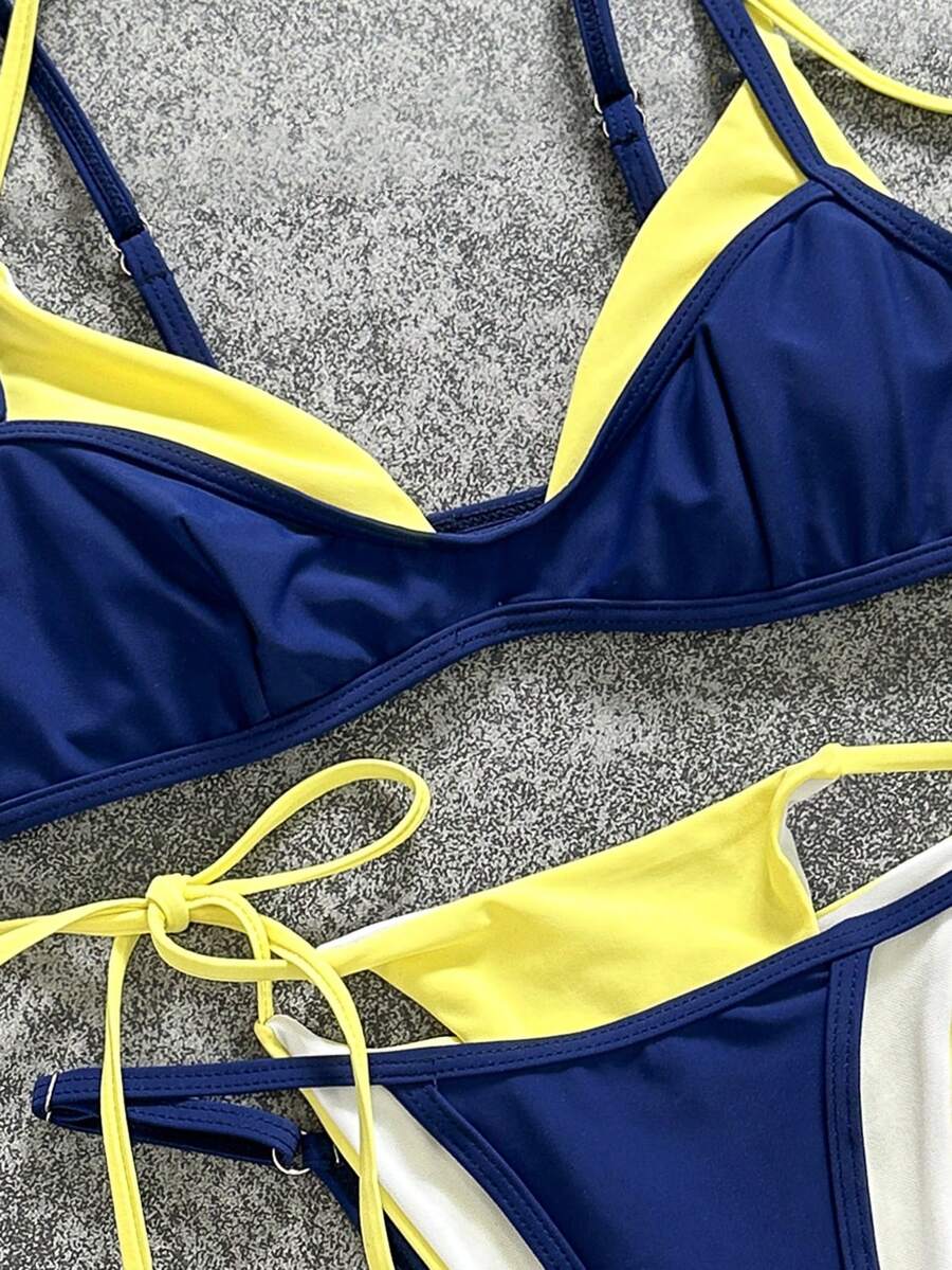 Women's retro polka dot high waist bikini swimsuit set with spaghetti straps and knot tie-back top.