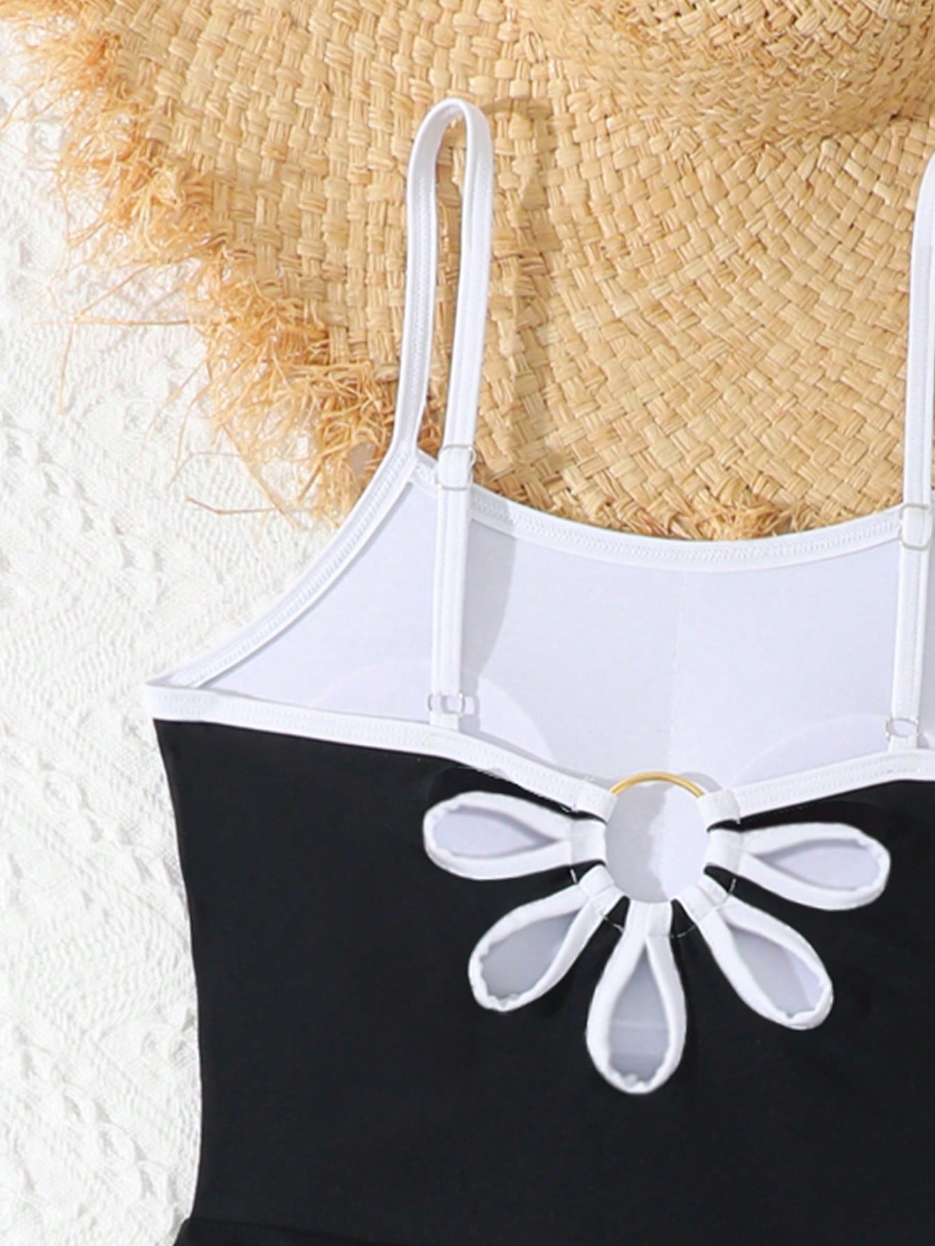 Tween girls black two-piece tankini swimwear set featuring a spaghetti strap sleeveless top with cutout detail and contrast piping, paired with short swim shorts.