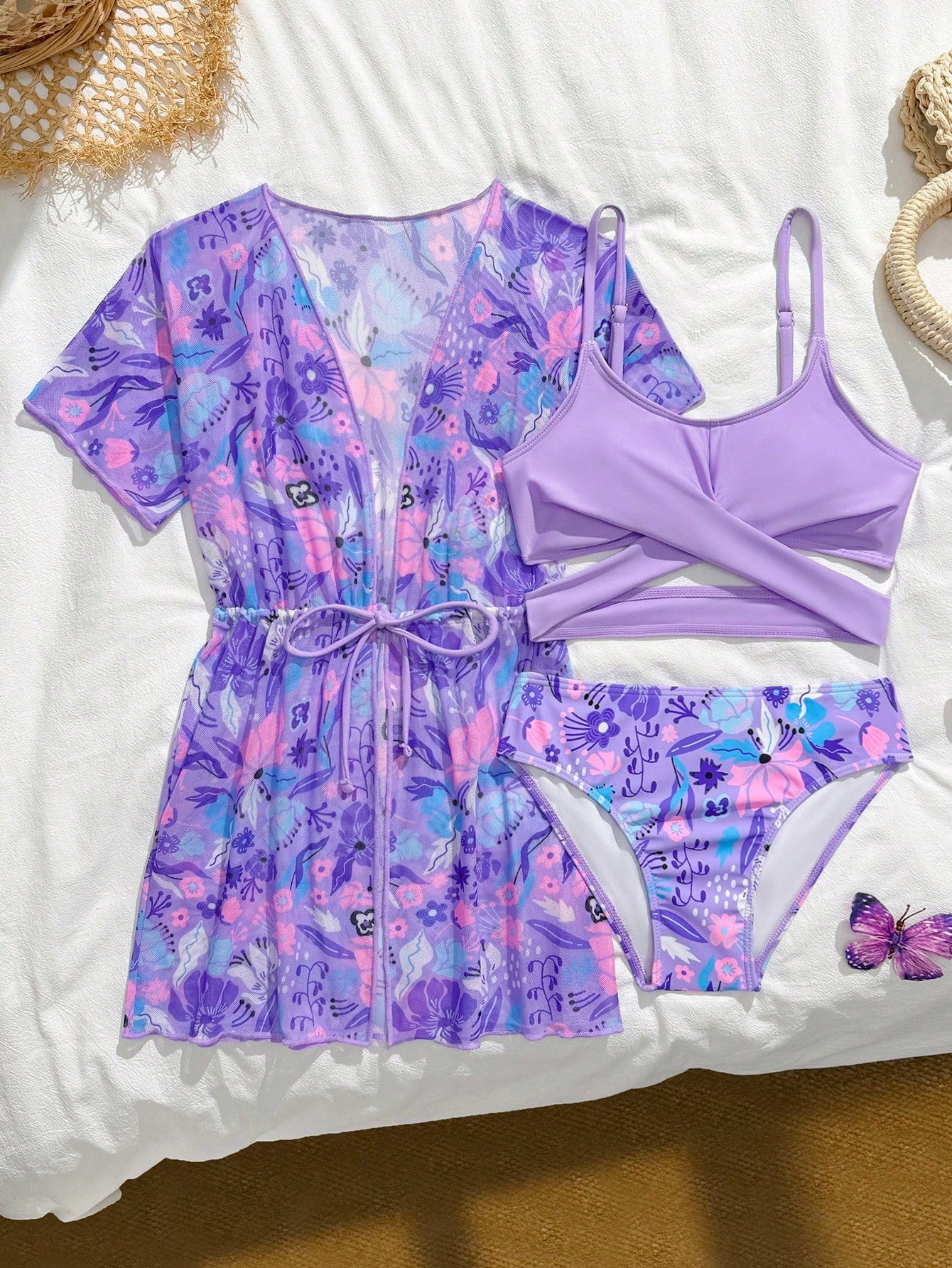 Three-piece tween girls swimwear set with a floral print, featuring a criss-cross bikini top, regular bikini bottoms, and a kimono cover-up in assorted prints.