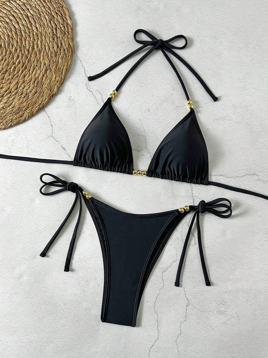 Women's black halter bikini set featuring triangle cups with gold bead decor and tie-back closure