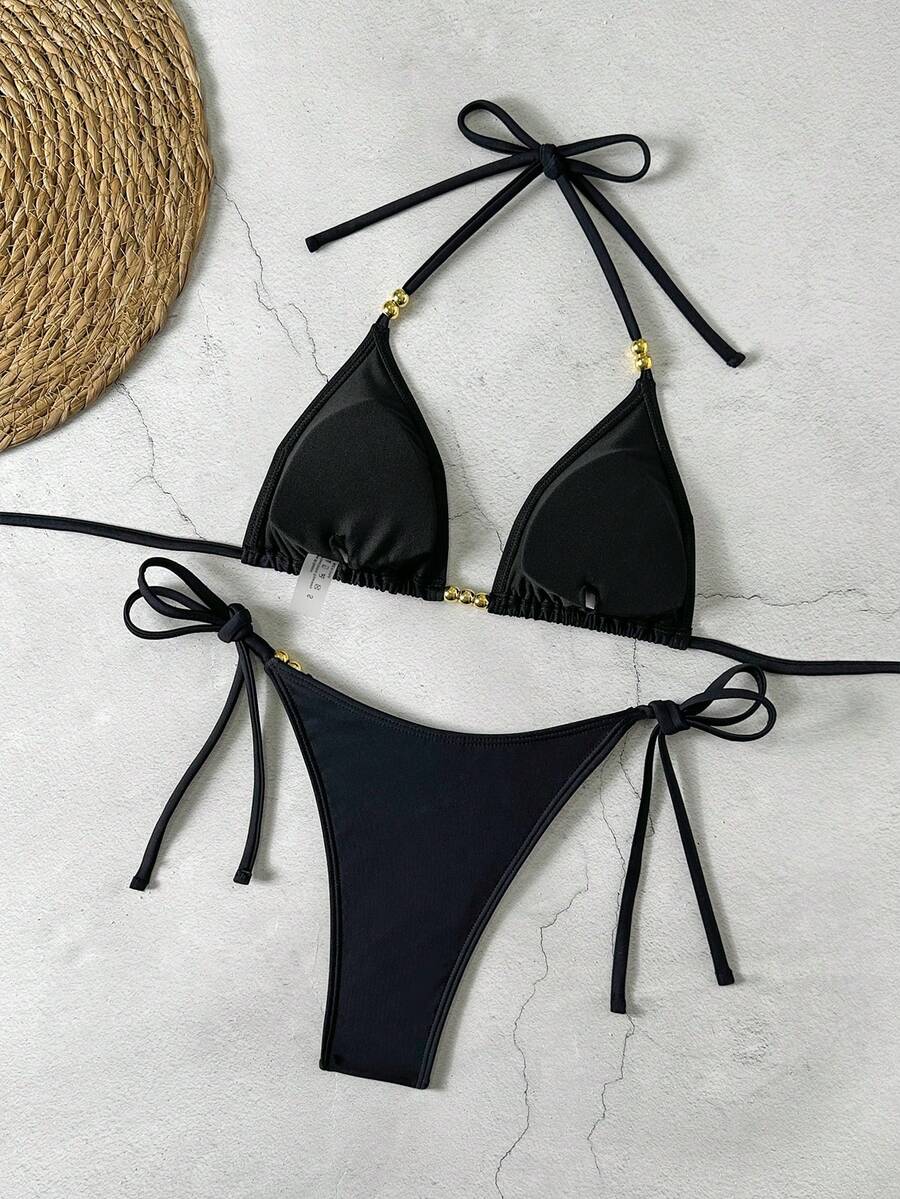 Women's black halter bikini set featuring triangle cups with gold bead decor and tie-back closure