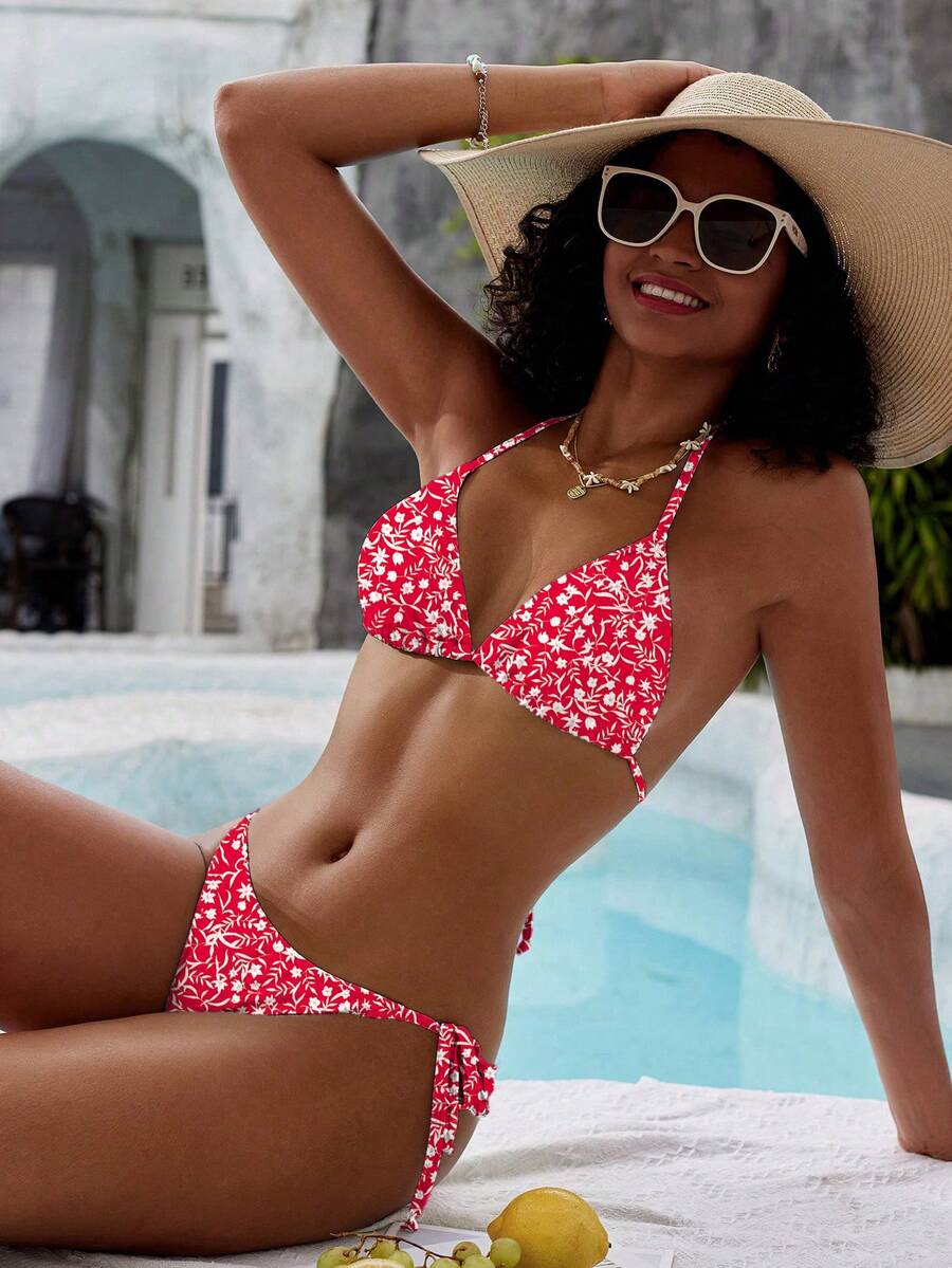 Women's black and white zebra print two-piece bikini set featuring a high waist tie-side bottom and a backless halter top with removable padding.