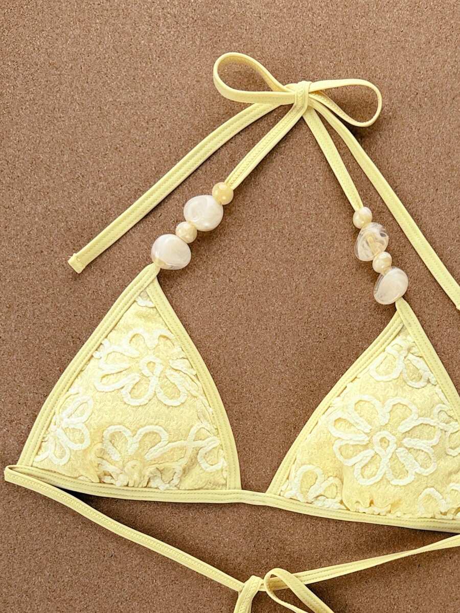 Women's apricot solid halter tie bikini top with triangle cups and matching tie-side swimsuit bottoms.