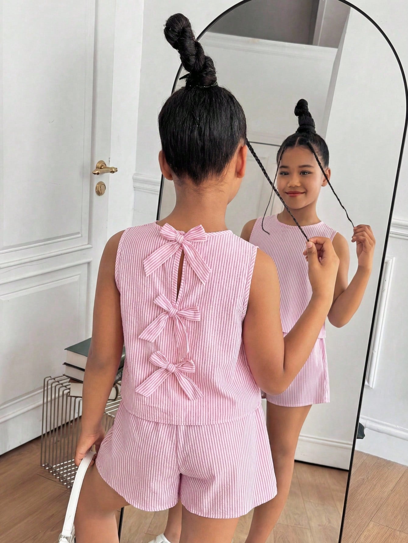 Tween girls casual blue tank top featuring round neck, textured fabric, and bow detail paired with matching shorts set.