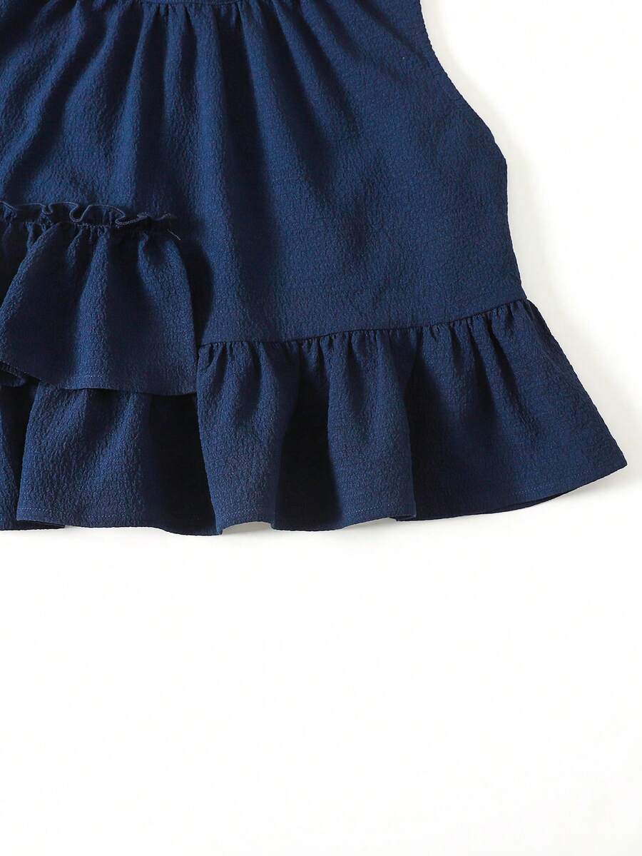Tween girls blue striped sleeveless short top with button and ruffle details paired with matching long straight leg pants.