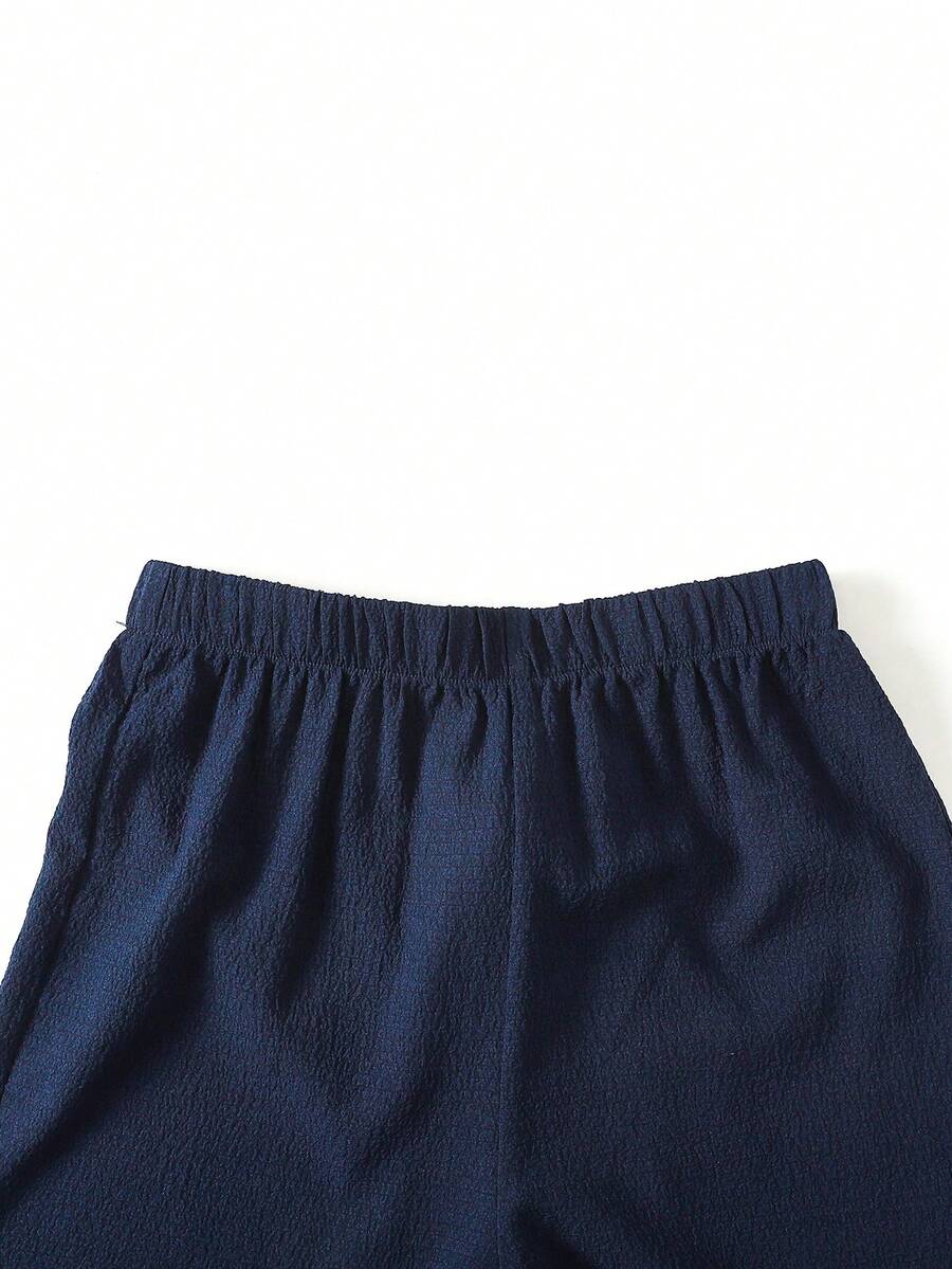Tween girls blue striped sleeveless short top with button and ruffle details paired with matching long straight leg pants.