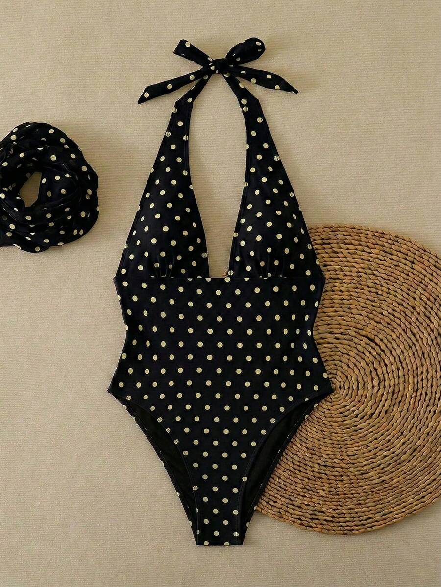 Women's apricot polka dot two-piece swimsuit featuring an asymmetrical halter backless top with knot tie detail and high-waisted bottoms.