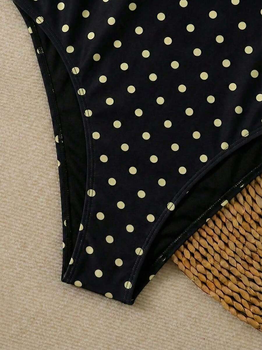 Women's apricot polka dot two-piece swimsuit featuring an asymmetrical halter backless top with knot tie detail and high-waisted bottoms.