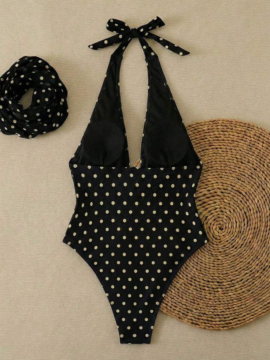 Women's apricot polka dot two-piece swimsuit featuring an asymmetrical halter backless top with knot tie detail and high-waisted bottoms.
