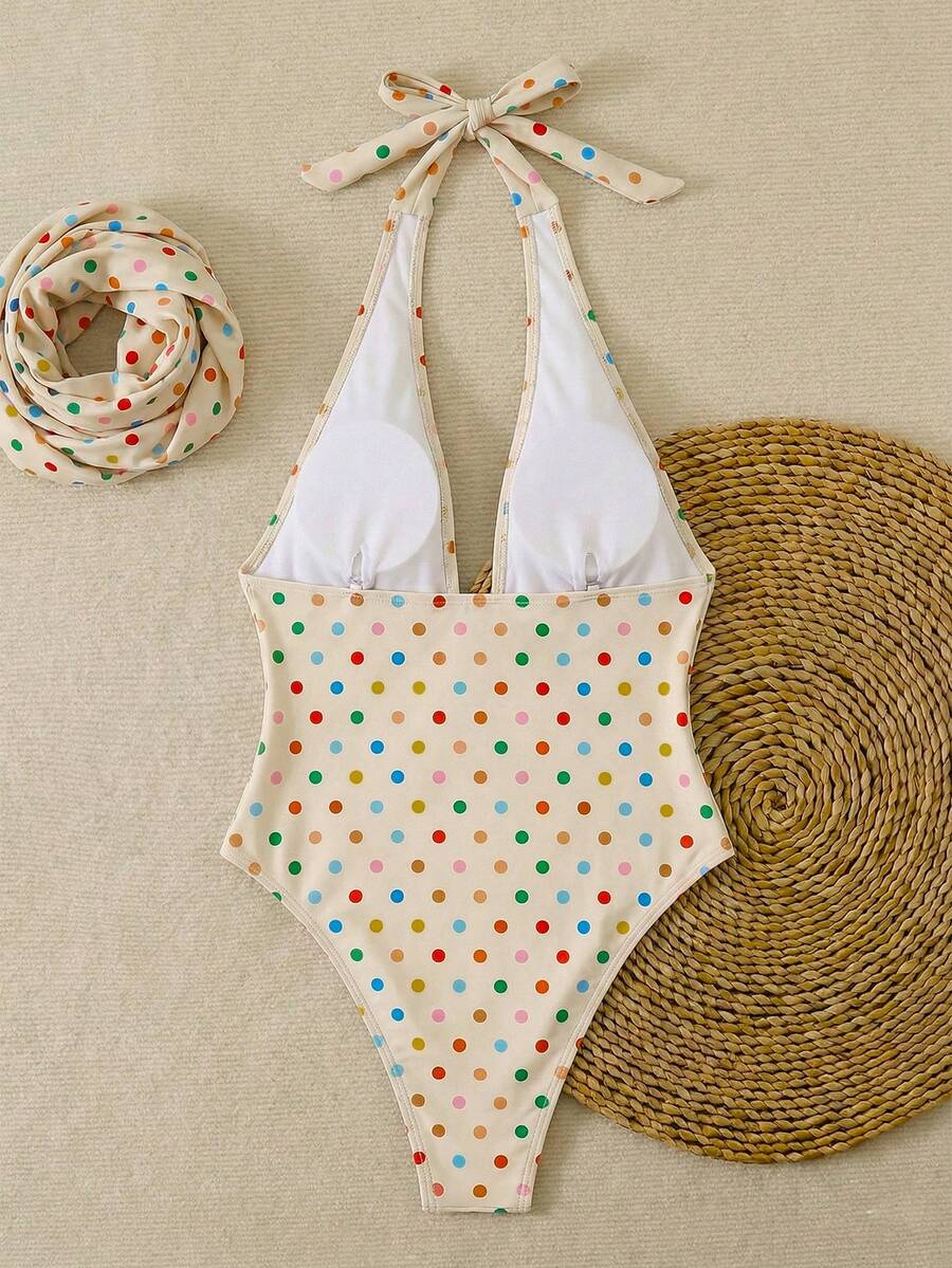 Women's apricot polka dot two-piece swimsuit featuring an asymmetrical halter backless top with knot tie detail and high-waisted bottoms.