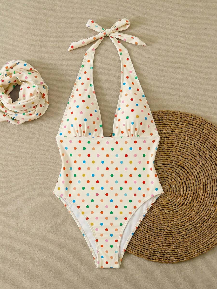 Women's apricot polka dot two-piece swimsuit featuring an asymmetrical halter backless top with knot tie detail and high-waisted bottoms.