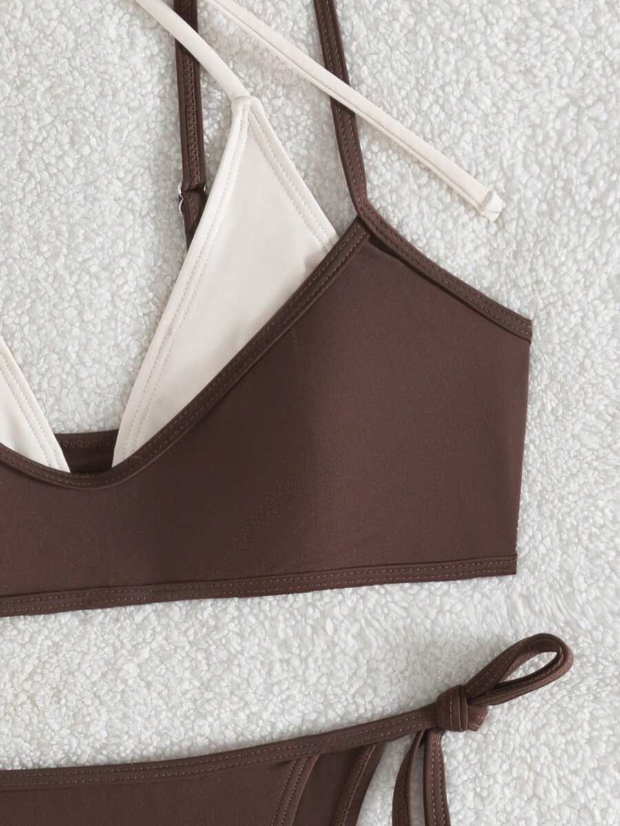 Women's color-block two-piece bikini set featuring a boho geometric pattern, tie-back halter top with removable padding, and matching tie-side bikini bottoms.