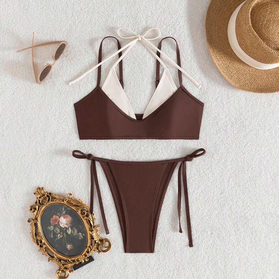 Women's color-block two-piece bikini set featuring a boho geometric pattern, tie-back halter top with removable padding, and matching tie-side bikini bottoms.