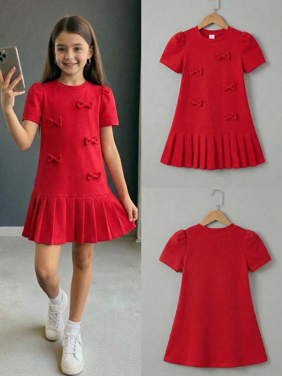 Tween girls apricot short-sleeve pleated smock dress with 3D bow decor and round neckline.