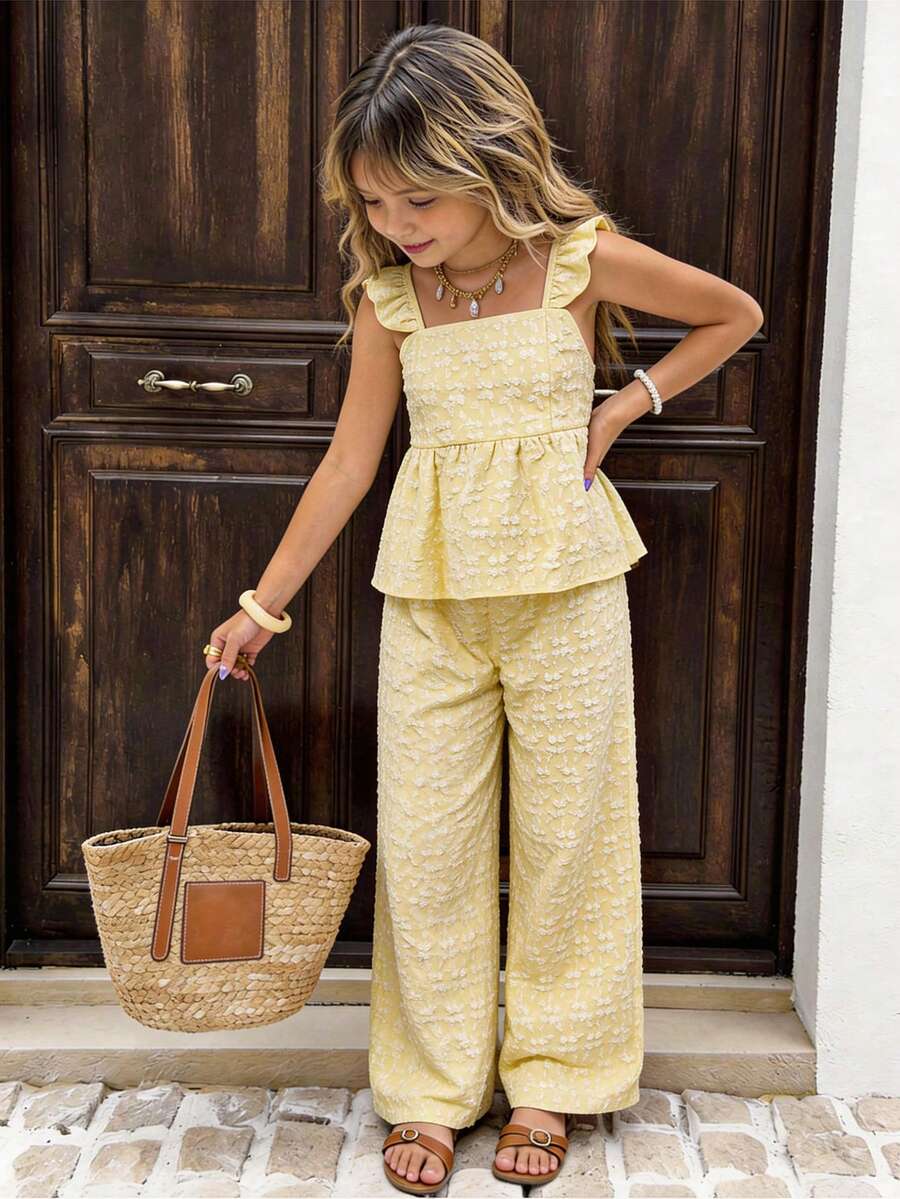 Tween girl wearing an apricot 2-piece outfit set featuring a shirred spaghetti strap short cami top and matching wide-leg long pants.