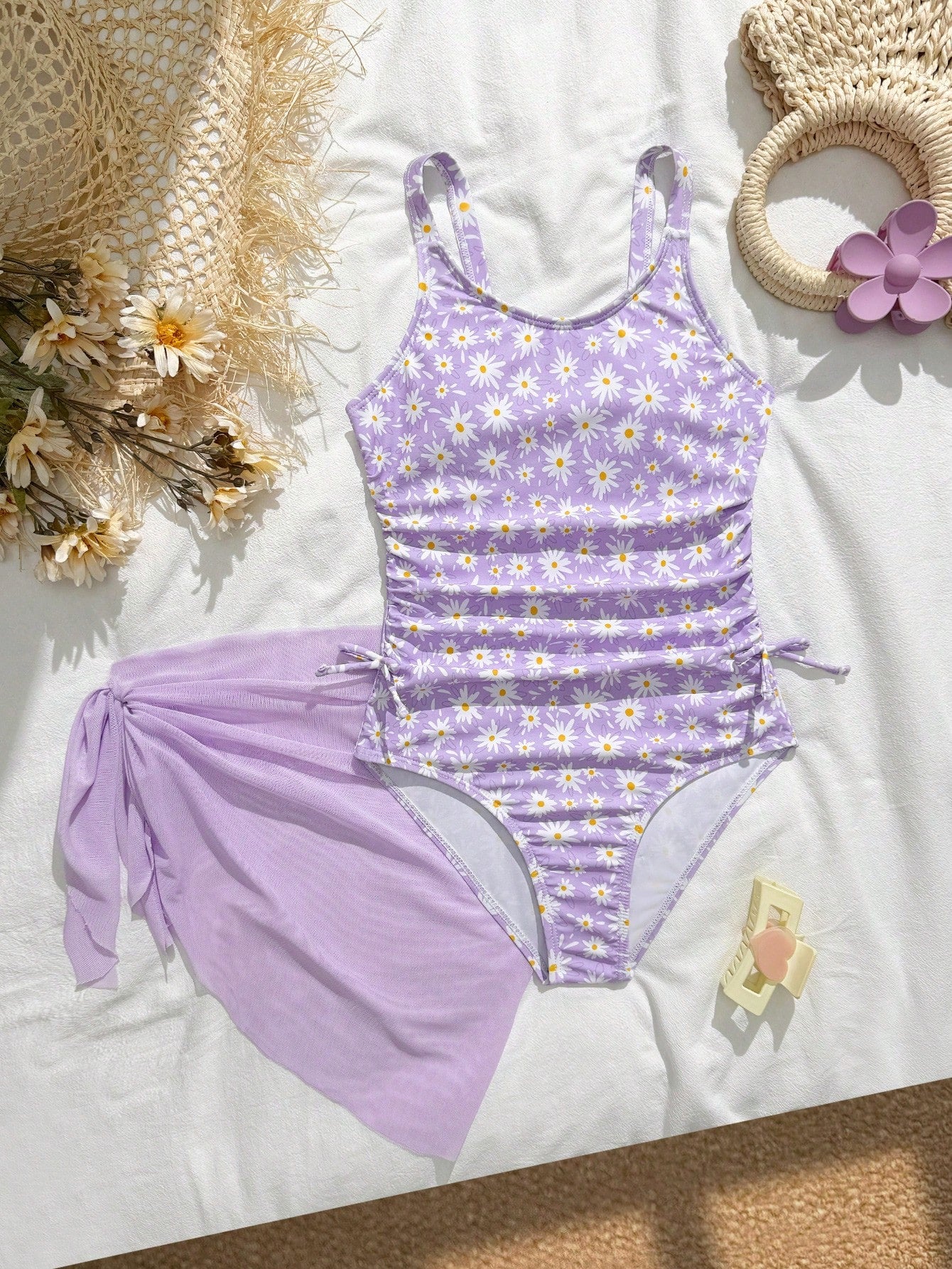 Tween girls 2-piece swimsuit in black with pink floral print, featuring spaghetti straps, bow decor, mesh detail, and a skirted mid-waist bottom. Sleeveless vacation-style swim set with medium-stretch fabric.