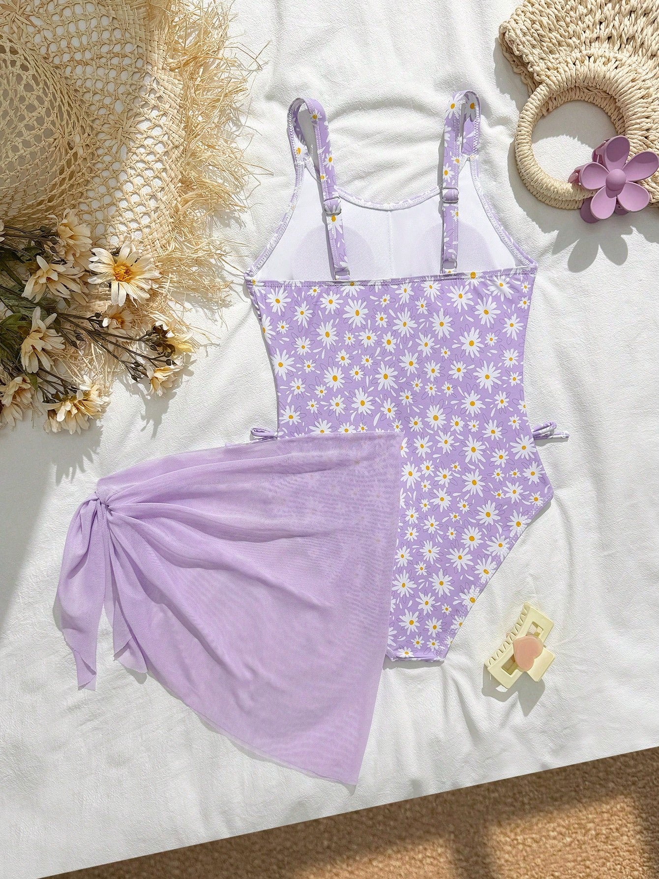 Tween girls 2-piece swimsuit in black with pink floral print, featuring spaghetti straps, bow decor, mesh detail, and a skirted mid-waist bottom. Sleeveless vacation-style swim set with medium-stretch fabric.