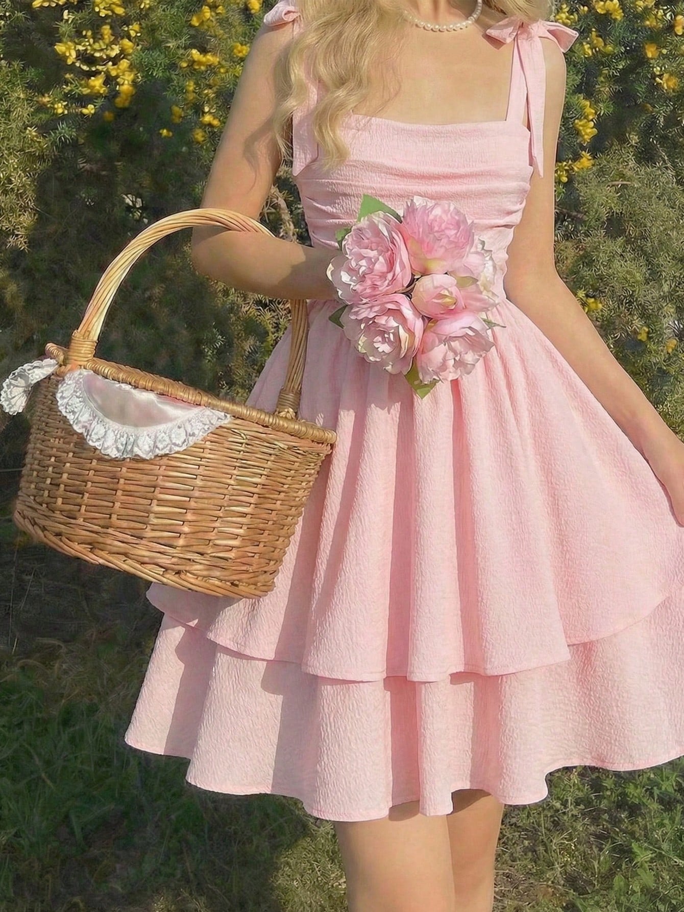 Tween girl wearing a pink tiered off-the-shoulder midi dress with shirred high waist and layered hem