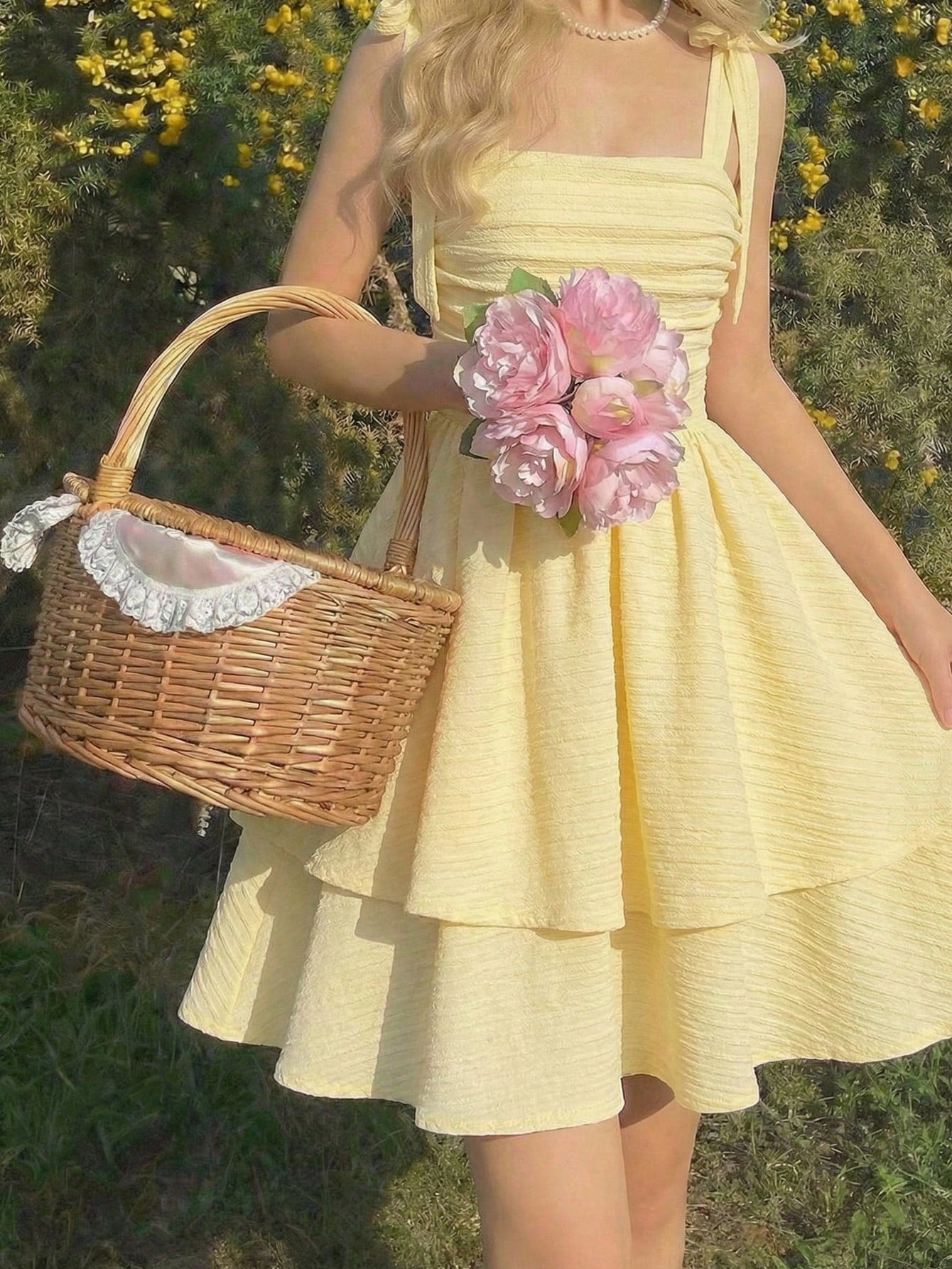 Tween girl wearing a pink tiered off-the-shoulder midi dress with shirred high waist and layered hem