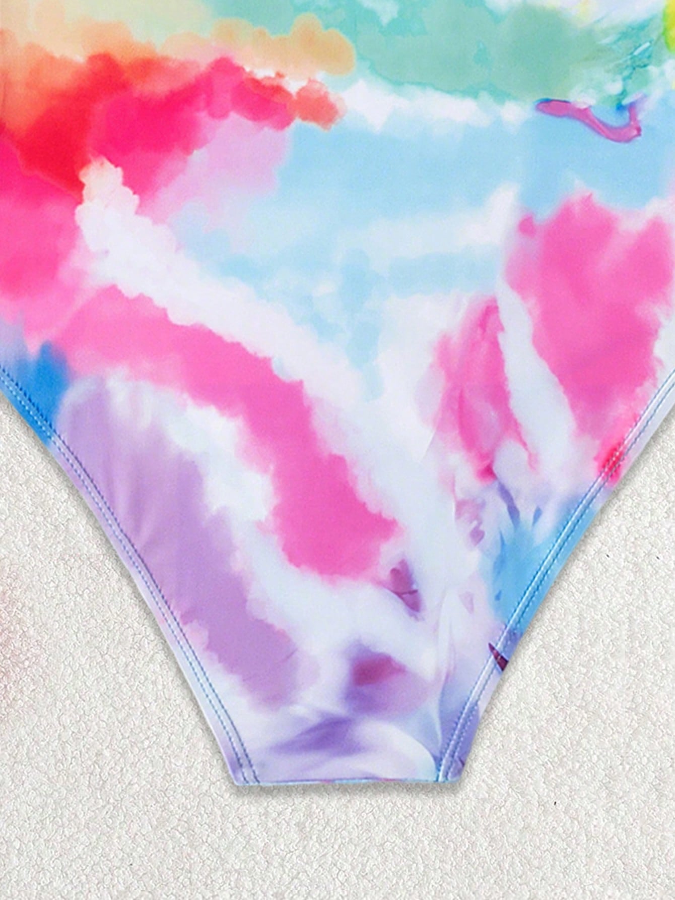 Multicolor plant print one-piece swimsuit for tween girls with spaghetti neckline, adjustable straps, fitted shape, and lined body for summer swimming and vacation.