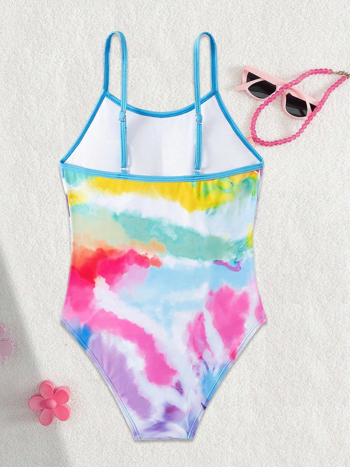 Multicolor plant print one-piece swimsuit for tween girls with spaghetti neckline, adjustable straps, fitted shape, and lined body for summer swimming and vacation.