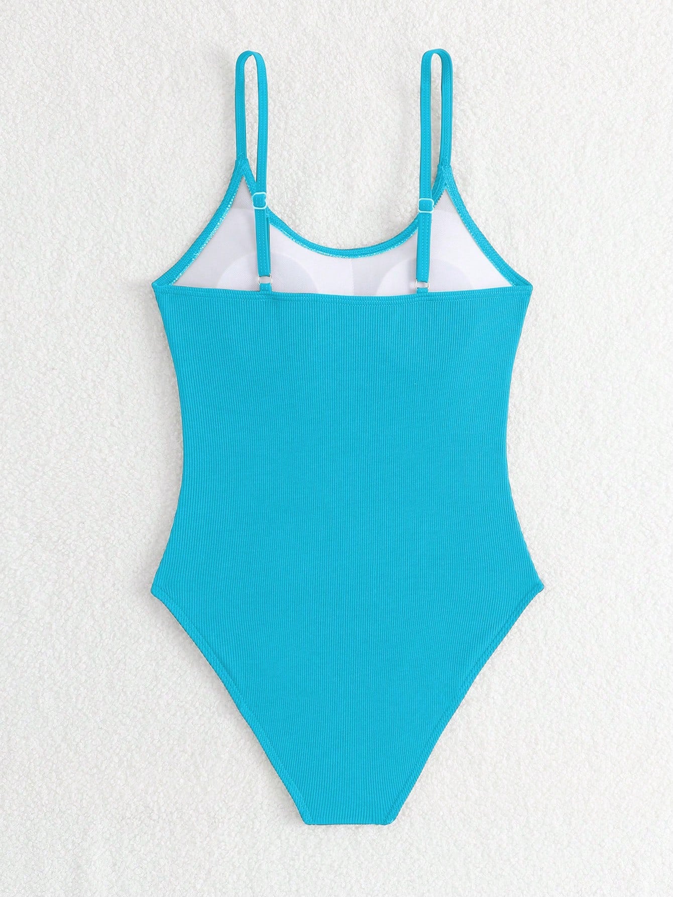 Purple rib knit one-piece swimsuit for tween girls with spaghetti straps, fitted shape, mid-waist bottom, wireless bra, and lined body.