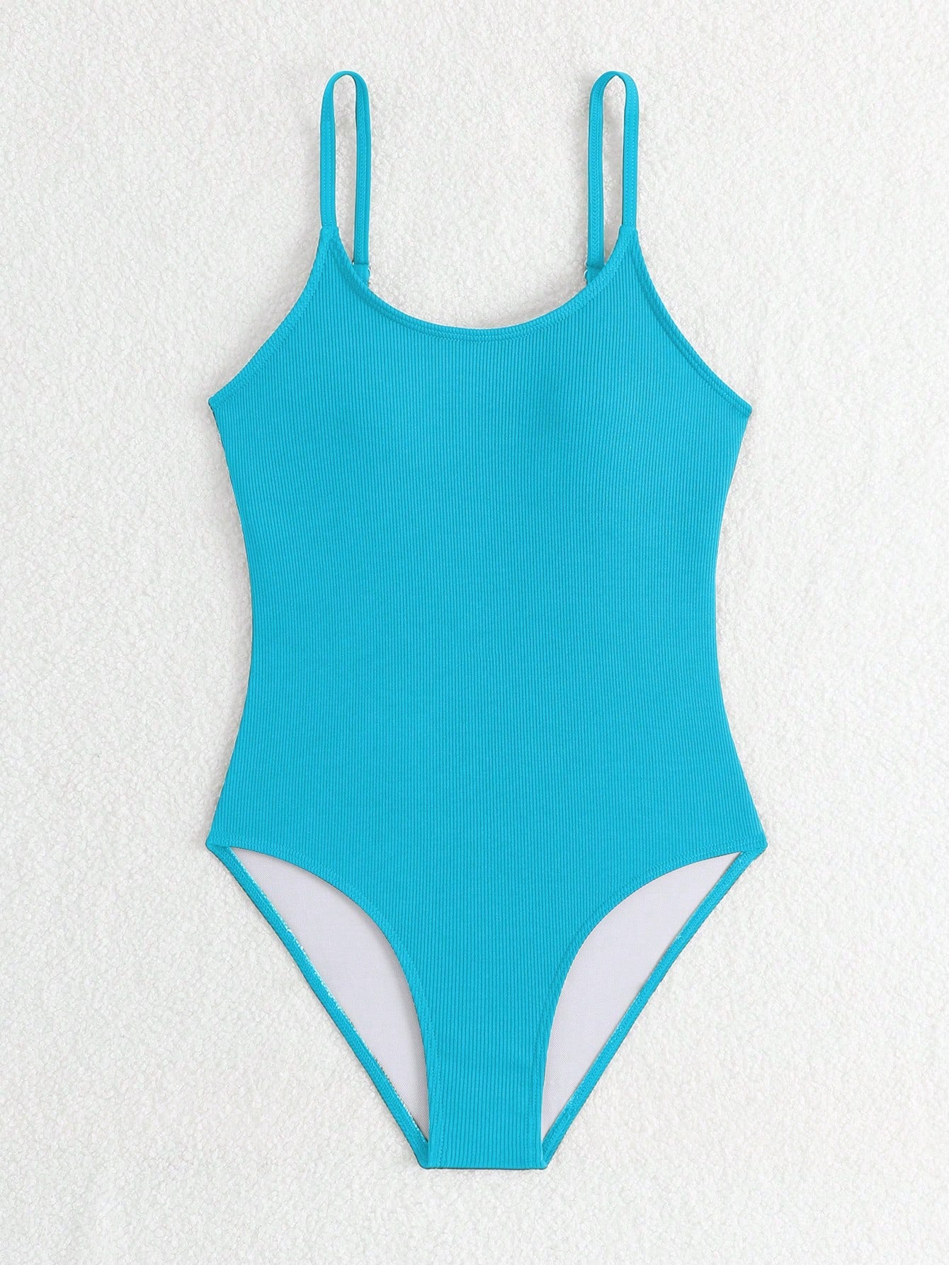 Purple rib knit one-piece swimsuit for tween girls with spaghetti straps, fitted shape, mid-waist bottom, wireless bra, and lined body.