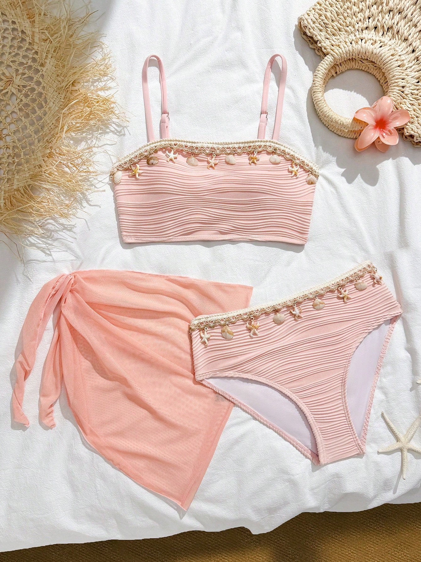 Tween girls bikini set with shell and starfish woven band details, spaghetti strap sleeveless top, and mid-waist skirt-style bottom in blue.