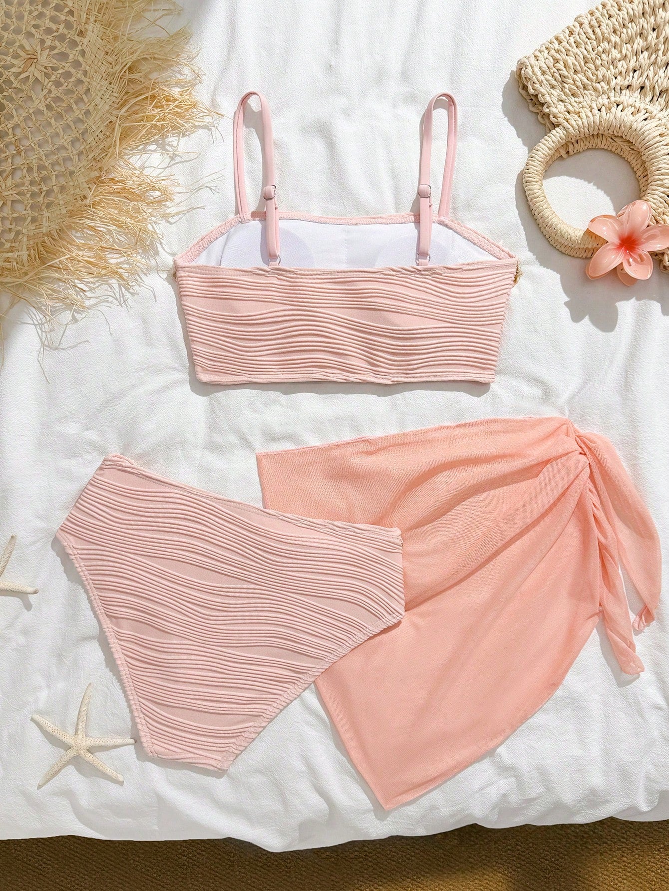 Tween girls bikini set with shell and starfish woven band details, spaghetti strap sleeveless top, and mid-waist skirt-style bottom in blue.