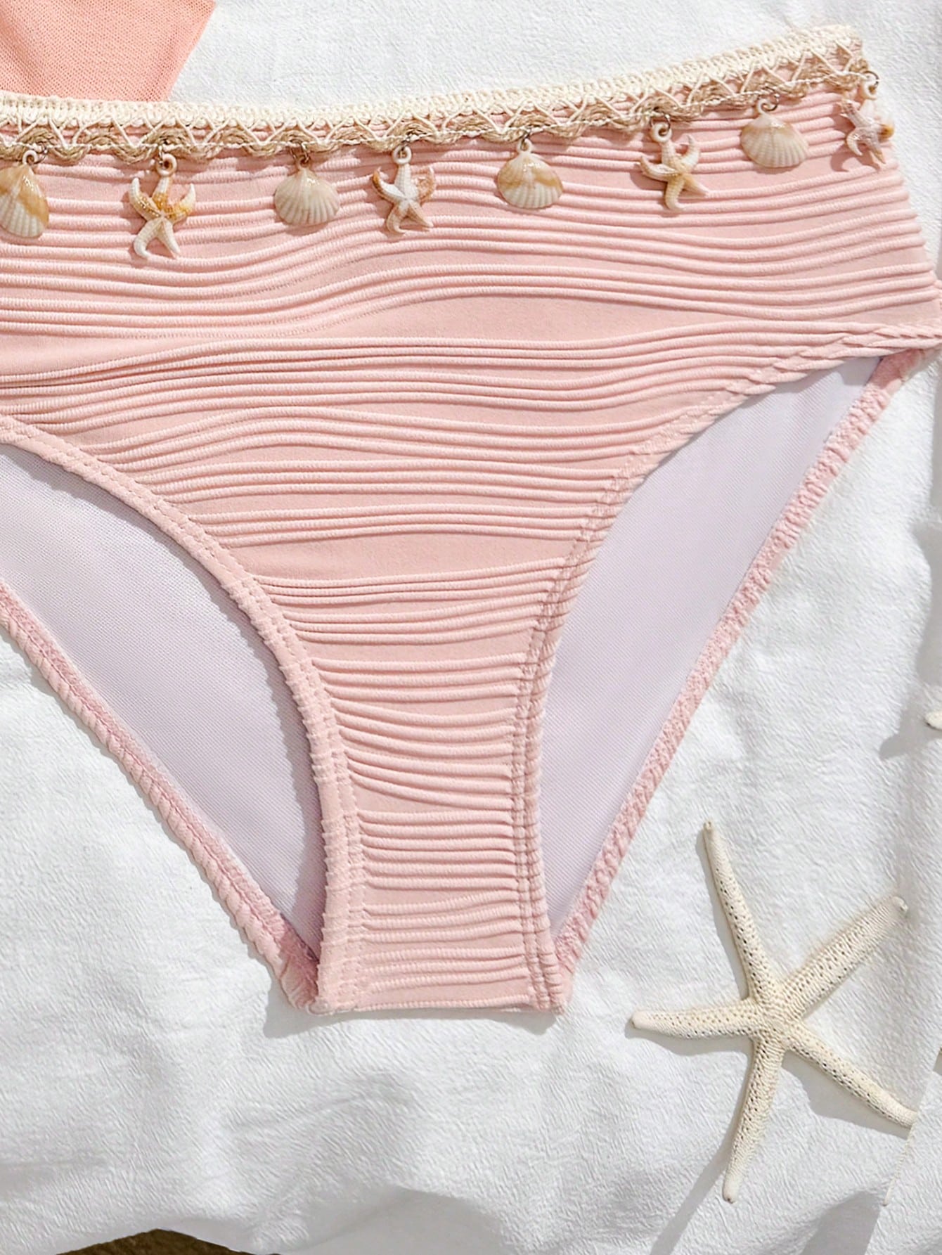 Tween girls bikini set with shell and starfish woven band details, spaghetti strap sleeveless top, and mid-waist skirt-style bottom in blue.