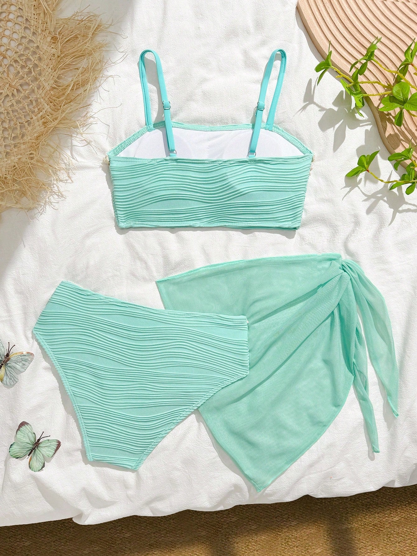 Tween girls bikini set with shell and starfish woven band details, spaghetti strap sleeveless top, and mid-waist skirt-style bottom in blue.