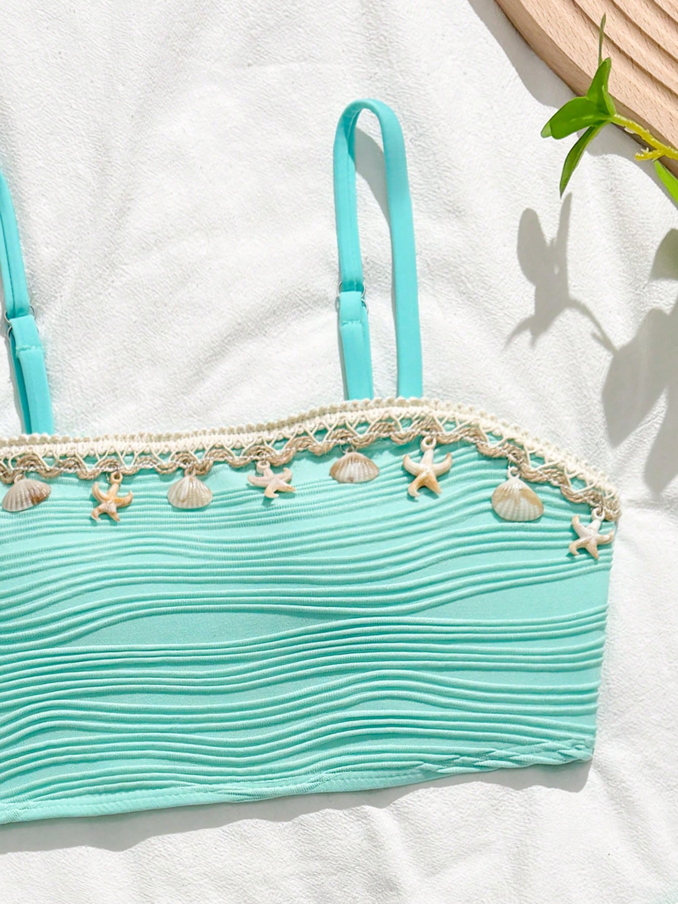 Tween girls bikini set with shell and starfish woven band details, spaghetti strap sleeveless top, and mid-waist skirt-style bottom in blue.